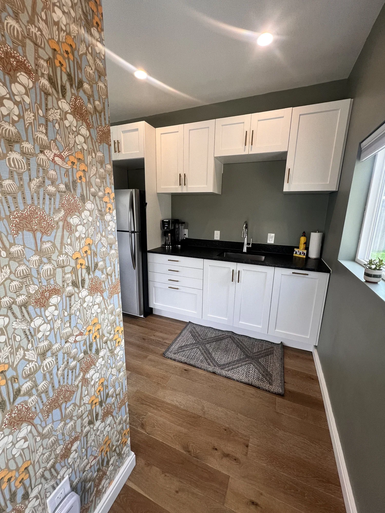 Efficient ADU kitchenette interior in Denver featuring white shaker cabinets, durable countertops, and space-saving layout designed and built by Prenvalley Builders.