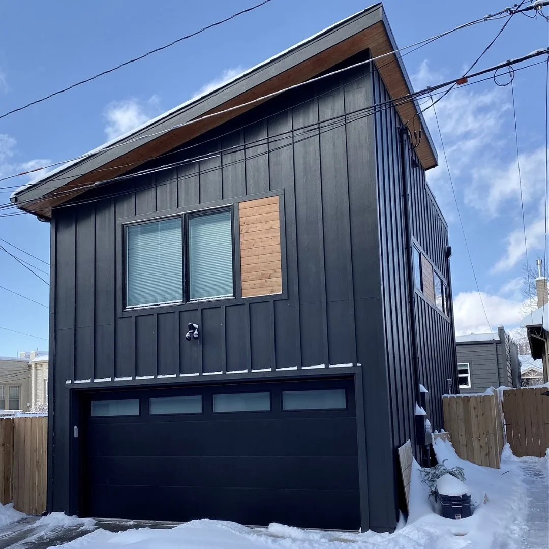 Completed garage accessory dwelling unit in Denver featuring a modern black exterior, sloped roof, vertical siding, and second-story living space built by Prenvalley Builders.
