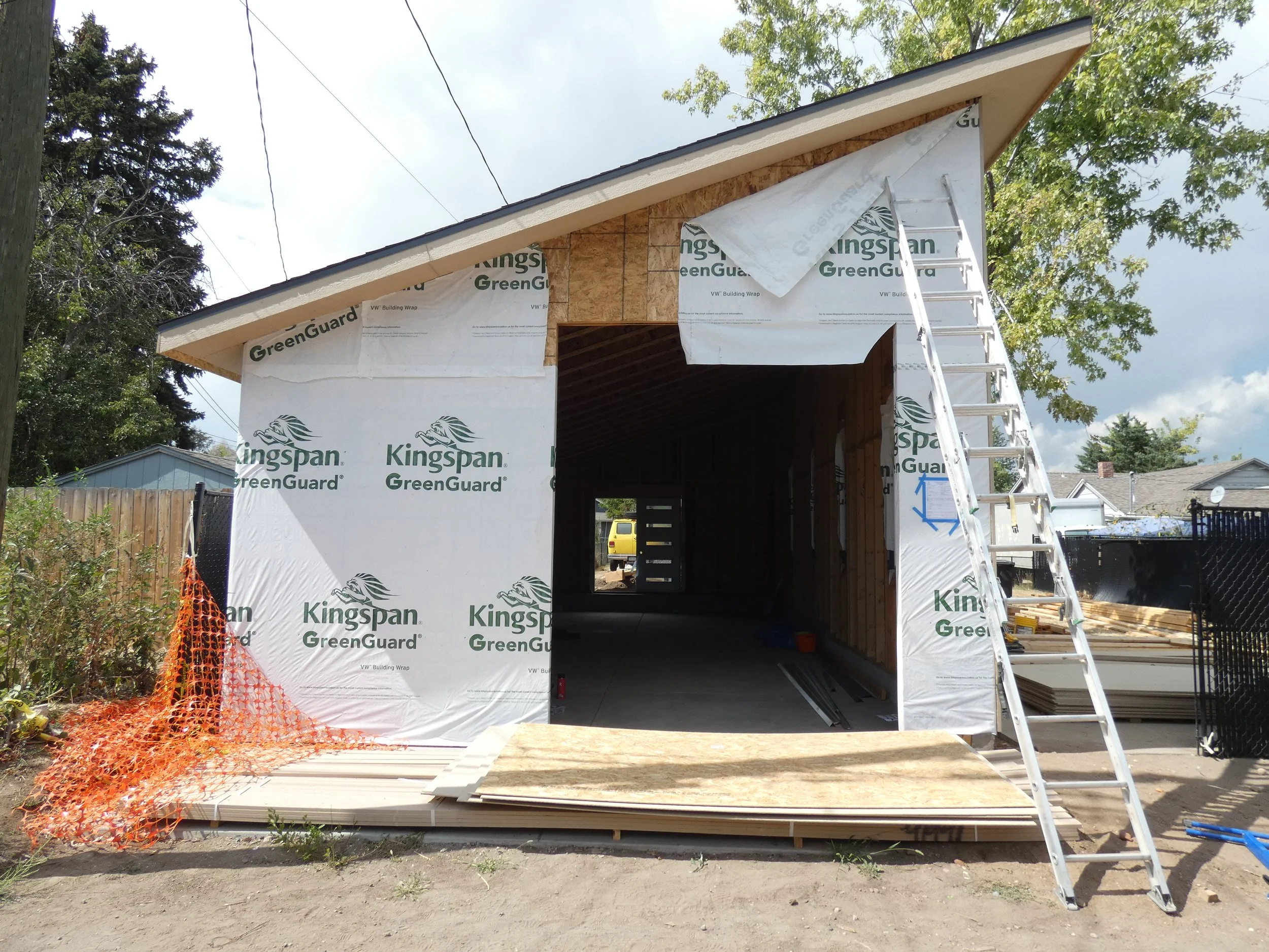 Front view of a custom garage under construction in Denver’s Barnum neighborhood, featuring a south-facing single-slope roof designed for future solar integration.