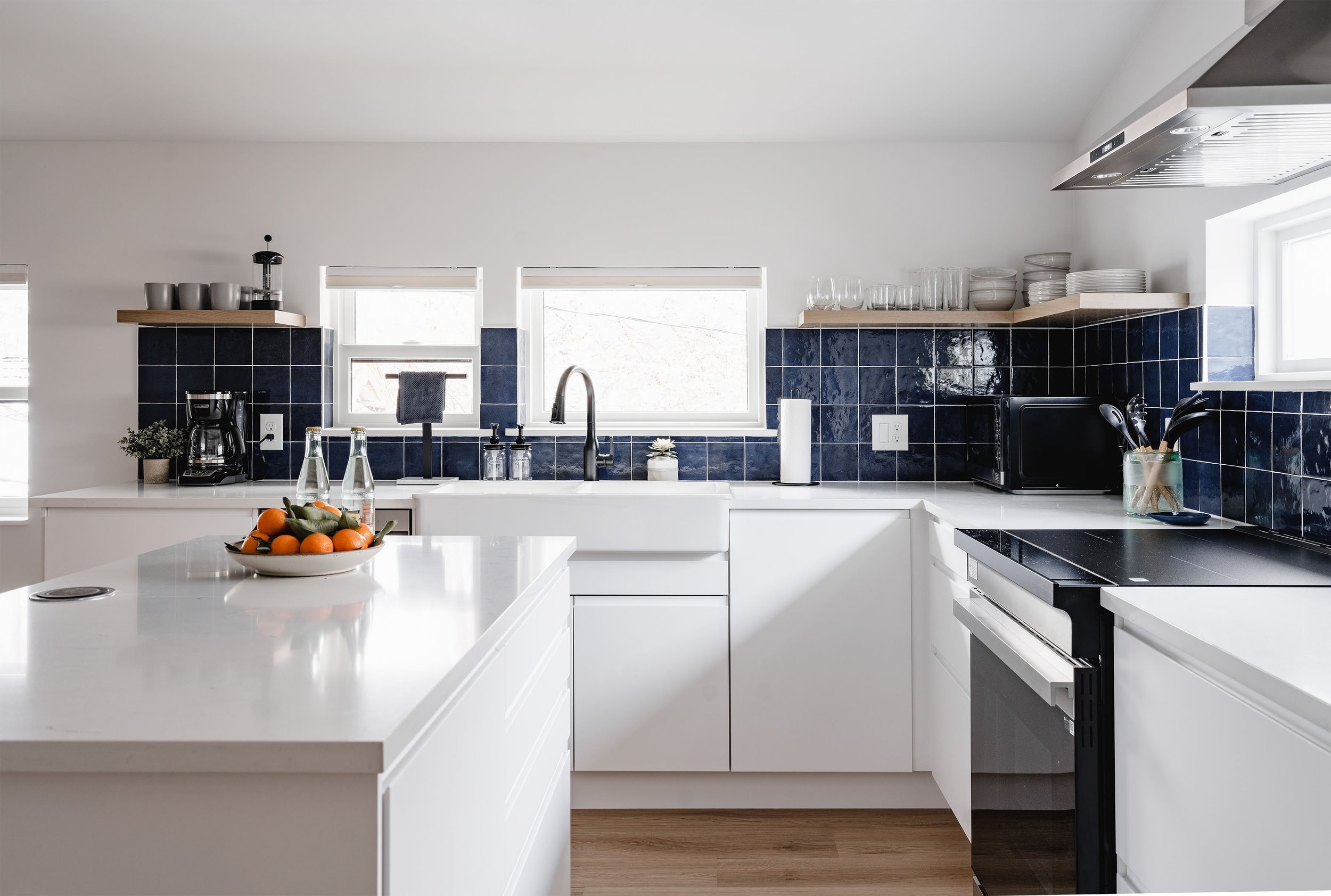 Kitchen sink and prep area inside a two-story design-build ADU in Denver, featuring modern fixtures, tiled backsplash, and durable finishes by Prenvalley Builders.