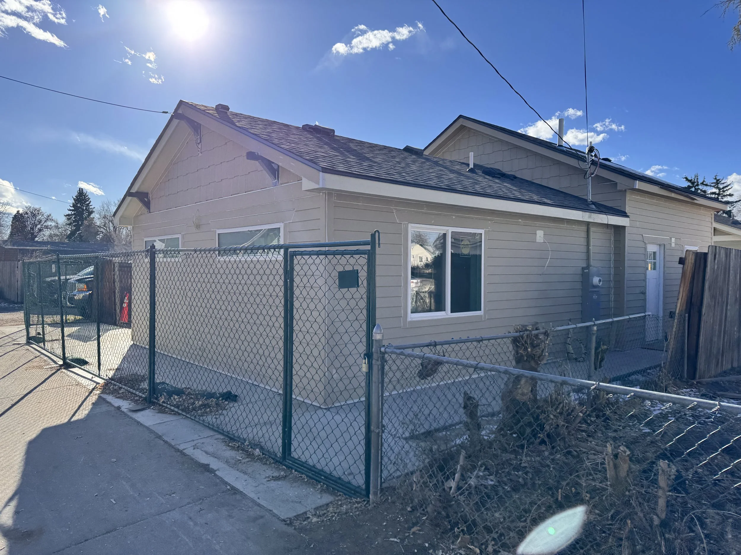 Existing garage exterior in Denver, Colorado prior to conversion into an accessory dwelling unit, showing original siding, roofline, and site conditions before construction.