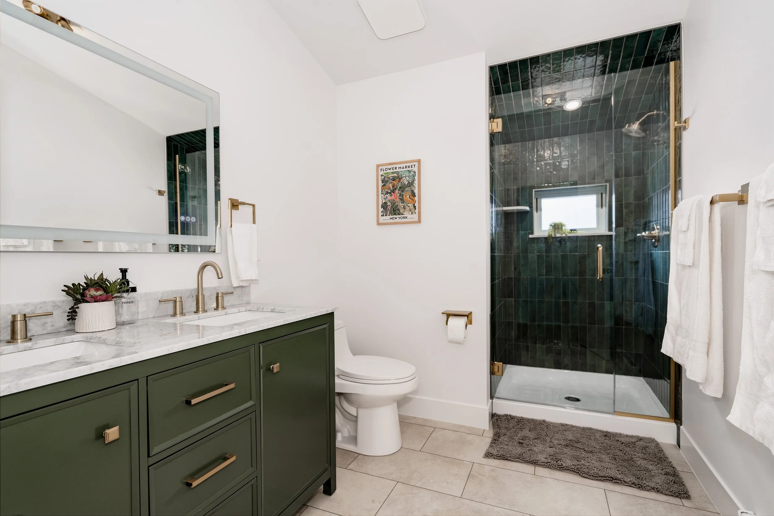 Bathroom inside a two-story design-build ADU in Denver, featuring a walk-in shower, custom vanity, and durable finishes by Prenvalley Builders.
