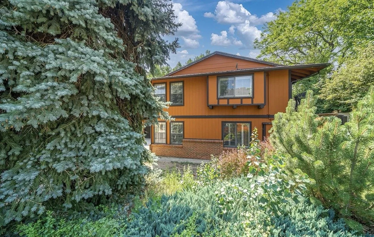 Before photo of the rear exterior of an existing home prior to a full interior renovation in Golden, Colorado by Prenvalley Builders.