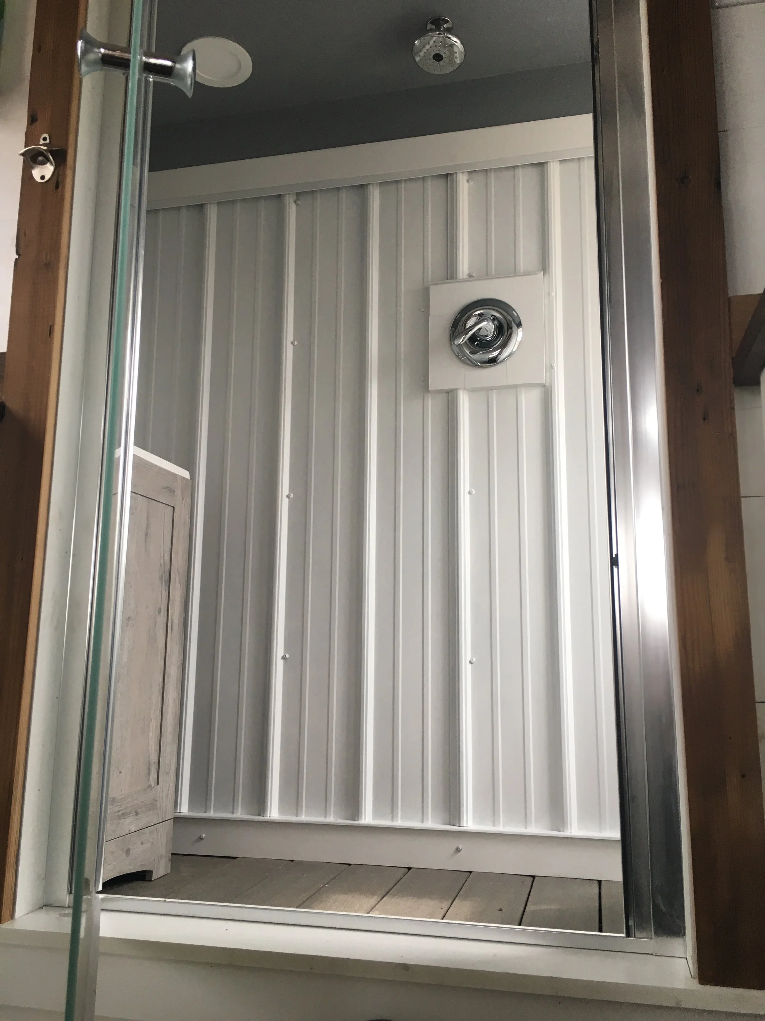 Bathroom shower in a custom mobile tiny home by Prenvalley Builders featuring durable wall panels, compact layout, and space-efficient fixtures designed for everyday use.