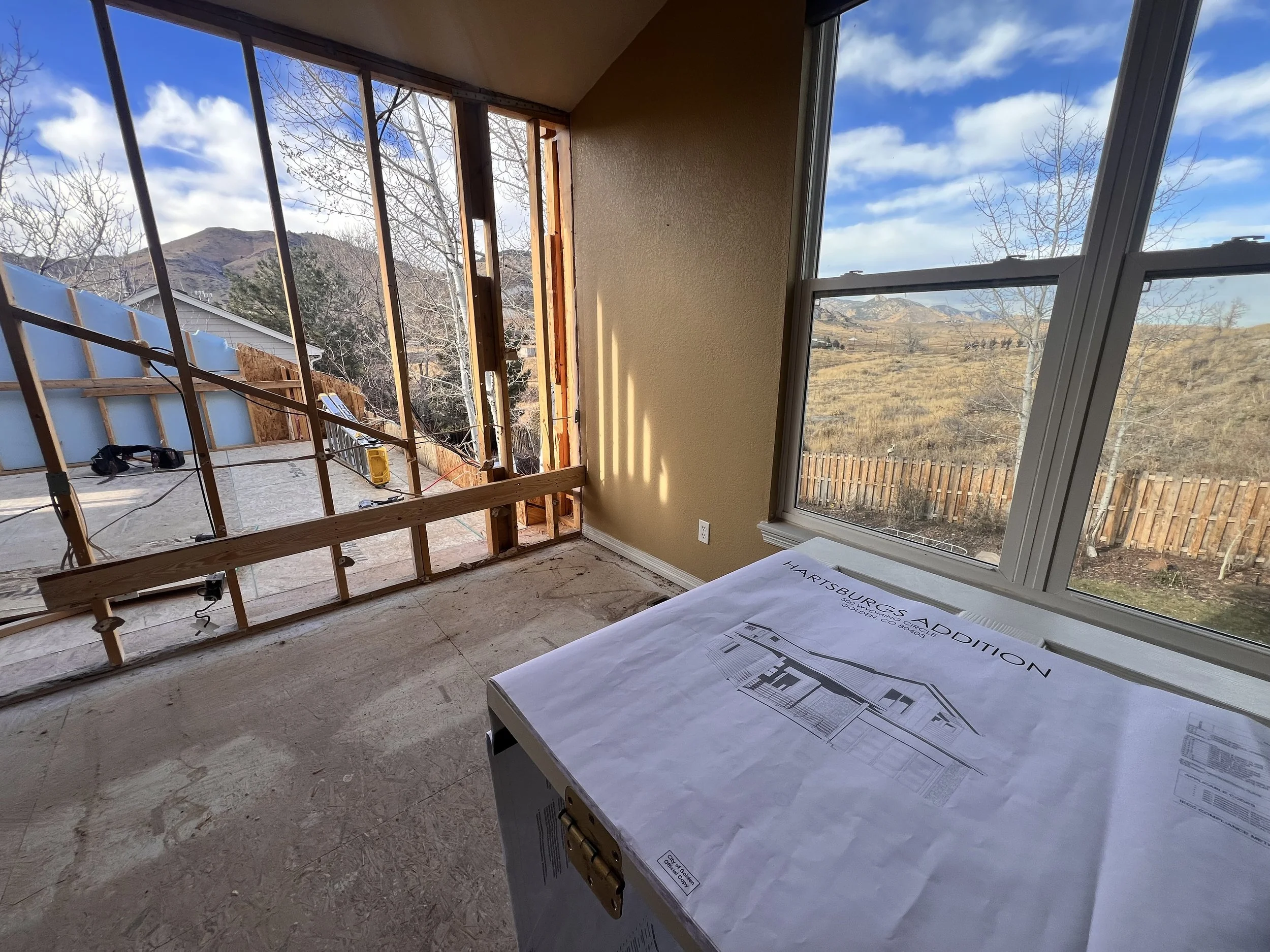 Interior construction phase of a pop-top renovation in Golden, Colorado, showing second-story framing and structural integration during a partial home addition.