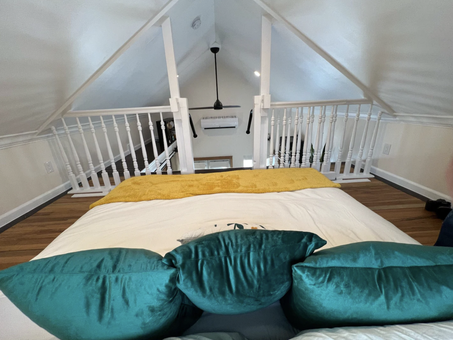 Loft sleeping area inside a detached accessory dwelling unit in Denver, Colorado, built by Prenvalley Builders, featuring a vaulted ceiling, guardrails, and space-efficient bedroom layout.