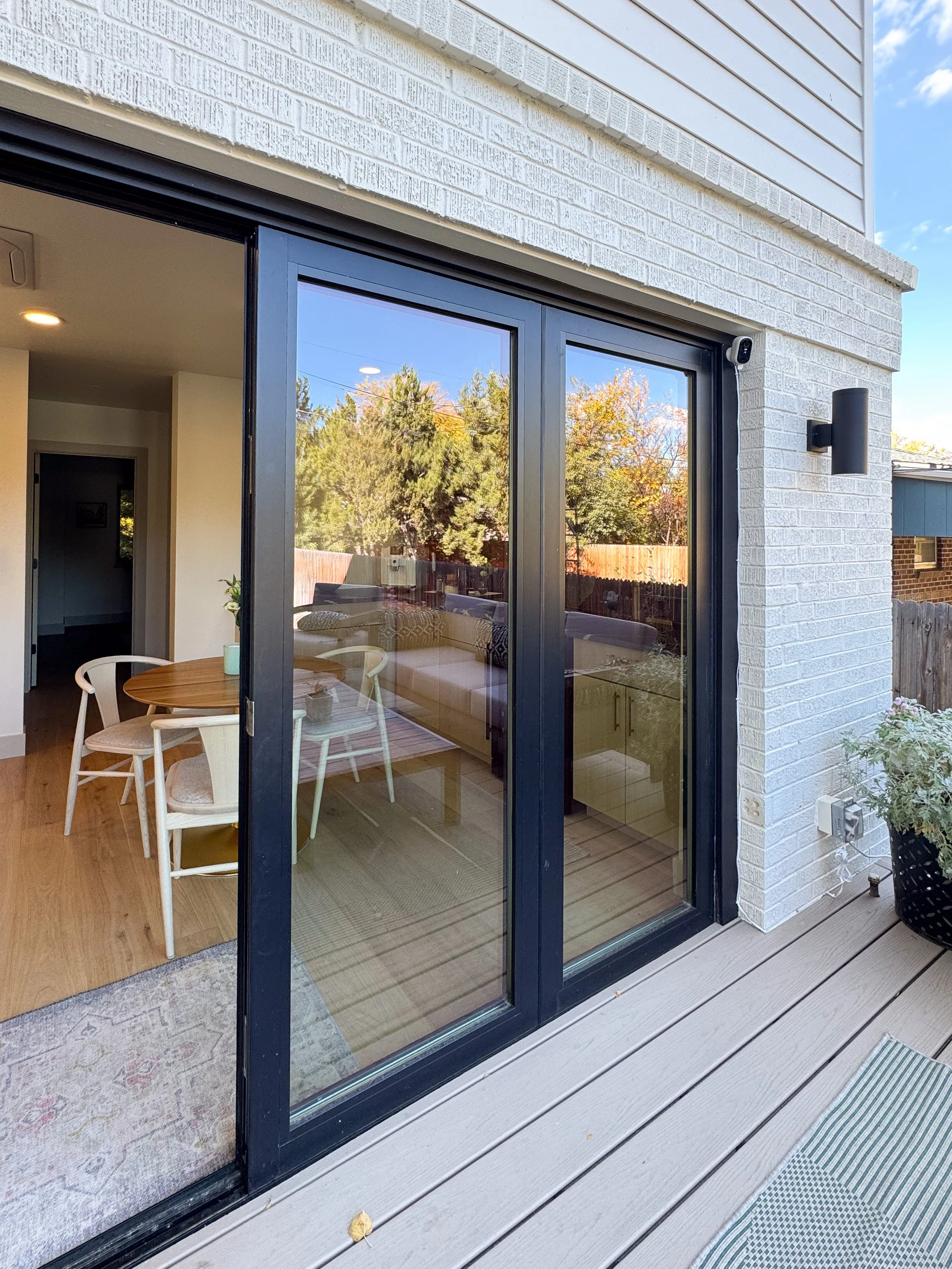 Sliding glass doors connecting the main living area to a rear deck in a Denver pop-top renovation