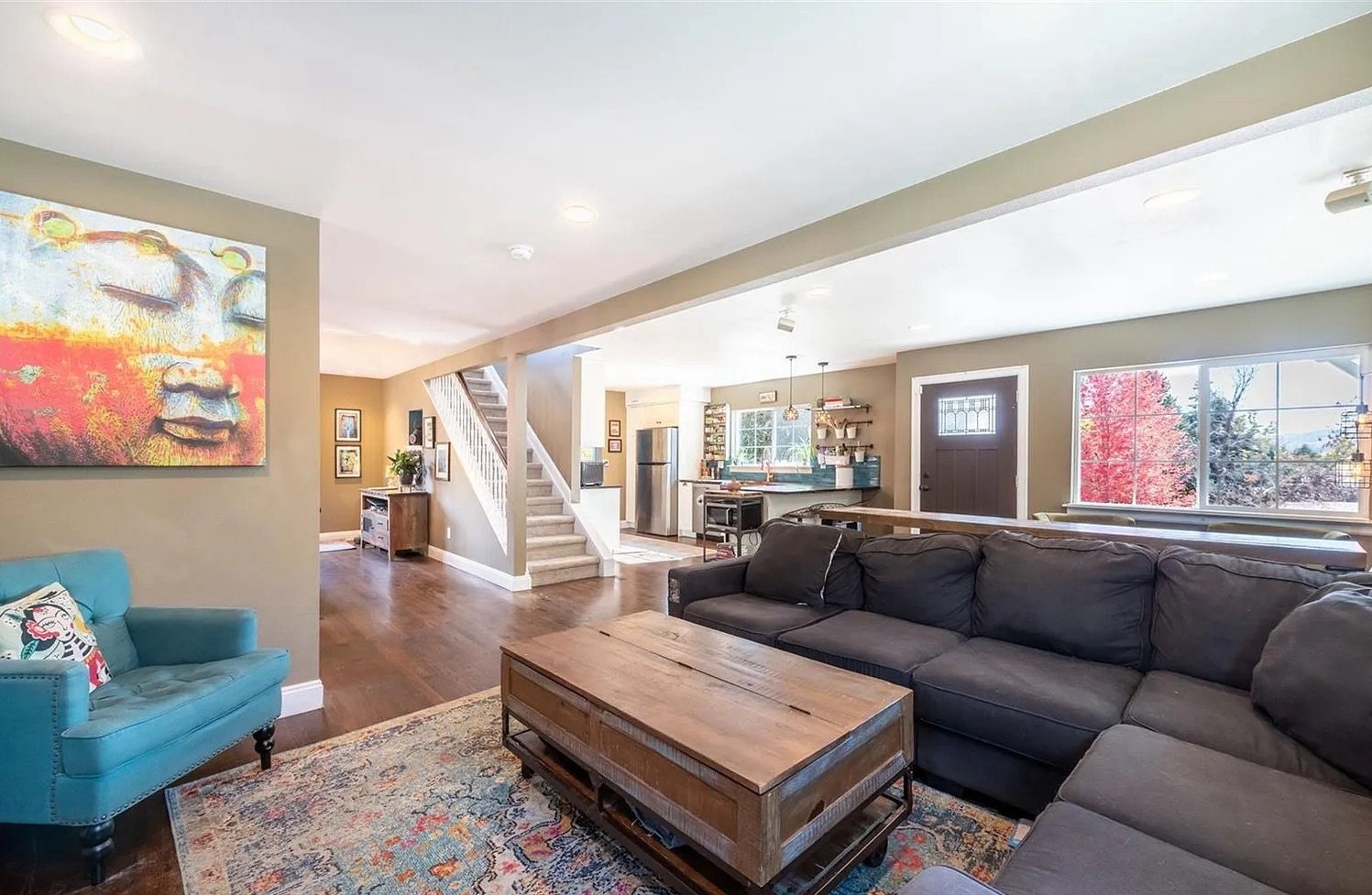 Completed main-level living area in a Golden, Colorado home following a second-story addition and whole-home renovation, featuring an open layout, updated finishes, and integrated stair access by Prenvalley Builders.