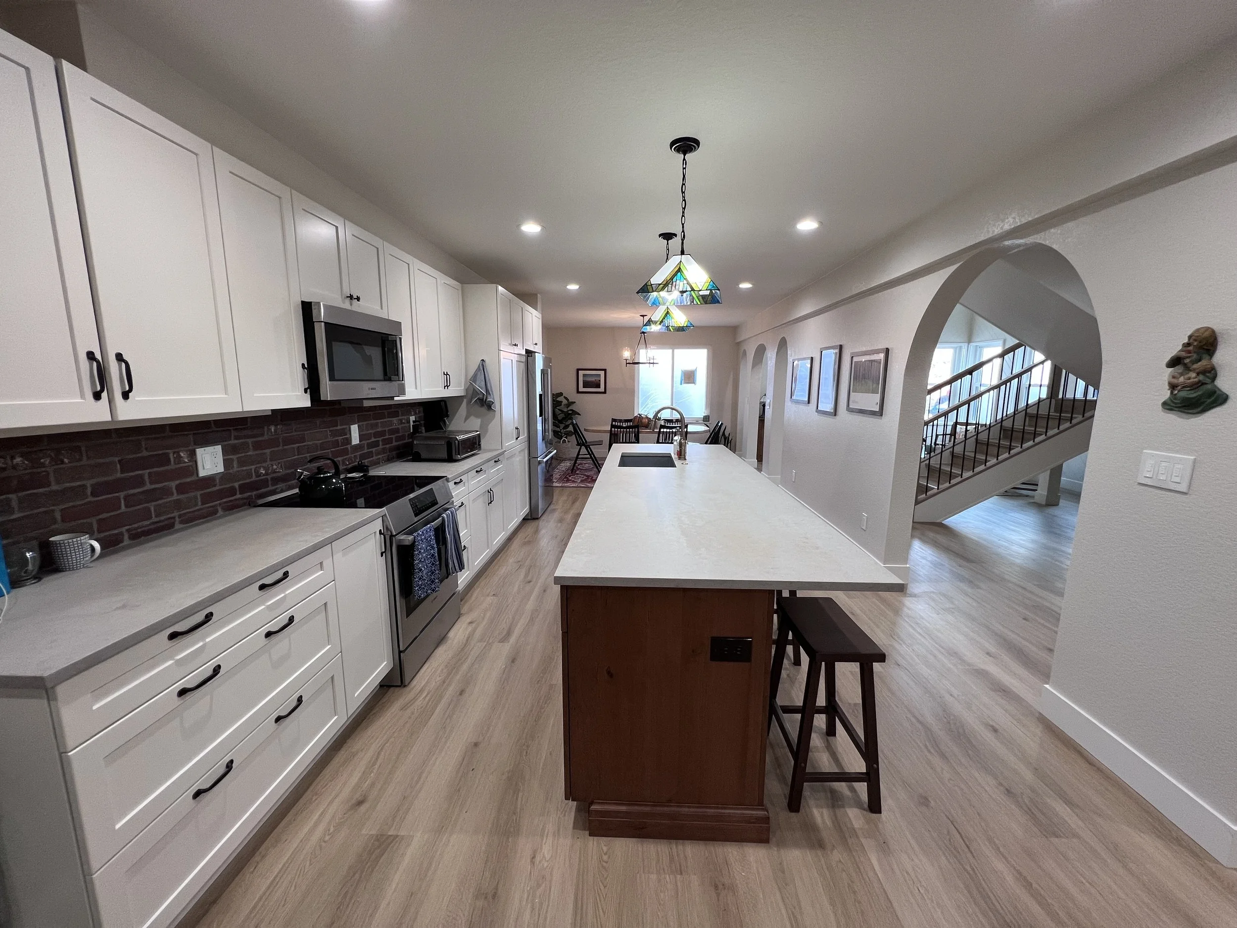 After photo of a renovated kitchen with a large island and open layout following a full interior renovation in Golden, Colorado by Prenvalley Builders.
