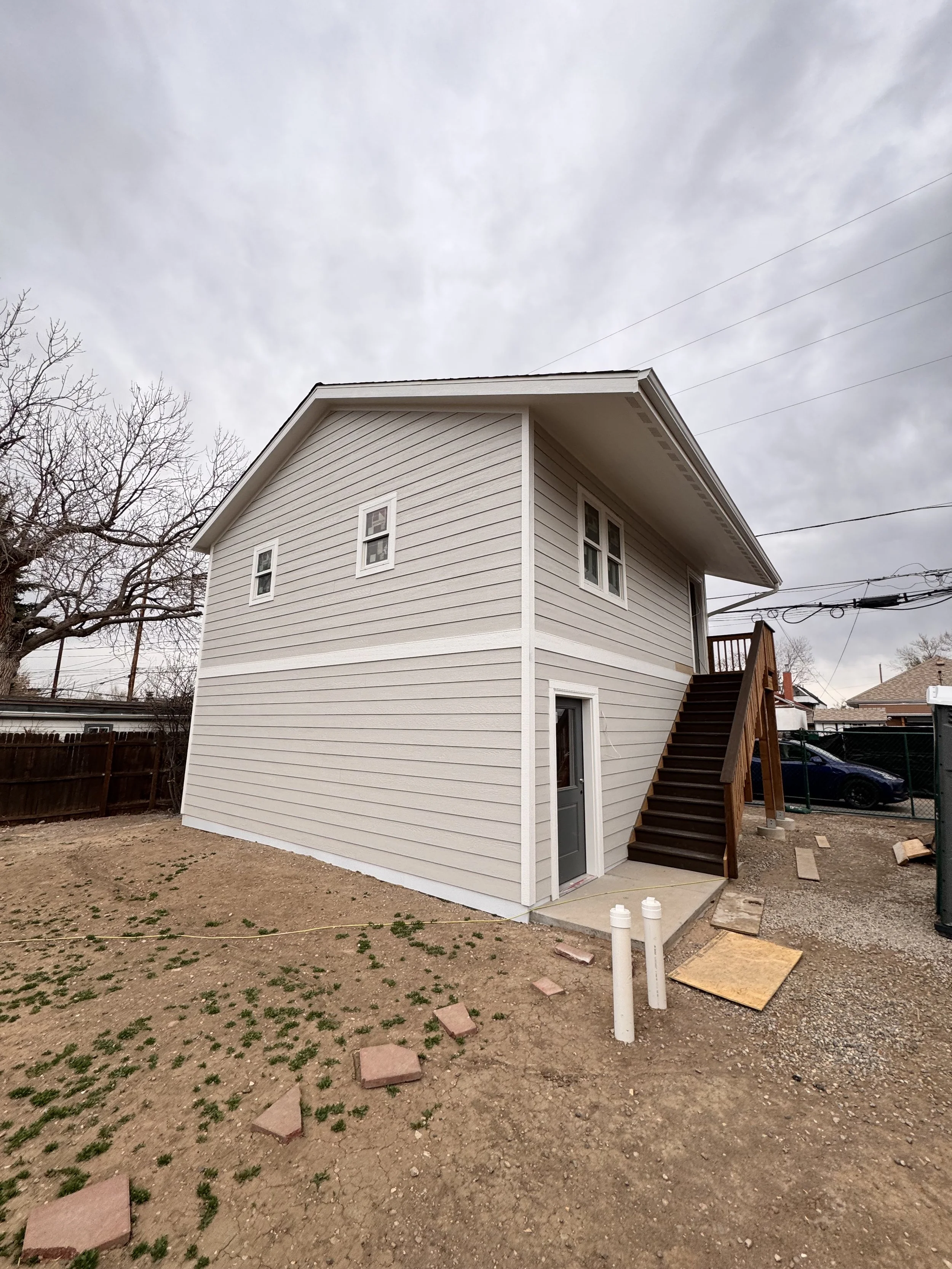 Finished accessory dwelling unit in Denver with exterior staircase and upper-level entry, built by Prenvalley Builders.