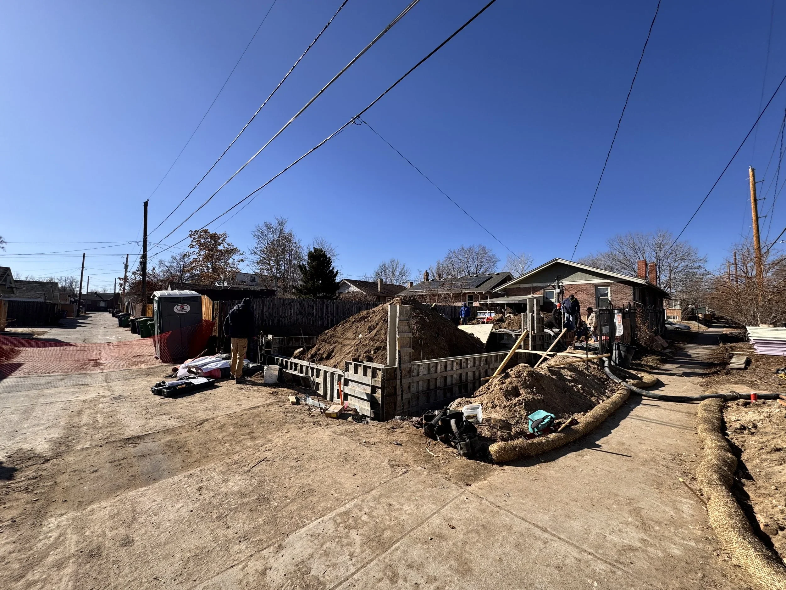 Early foundation construction of a custom design-build ADU in Denver showing formwork, excavation, and site preparation by Prenvalley Builders
