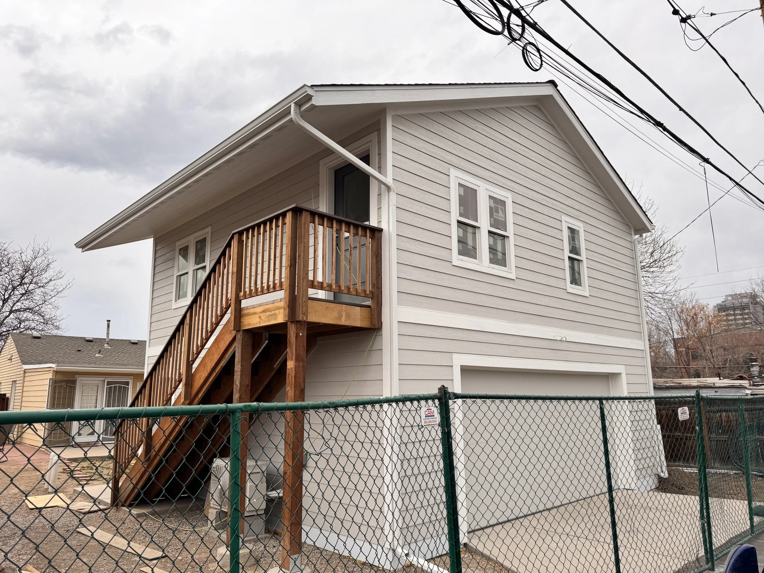 Finished two-story accessory dwelling unit in Denver with integrated garage and exterior stair access, built by Prenvalley Builders.