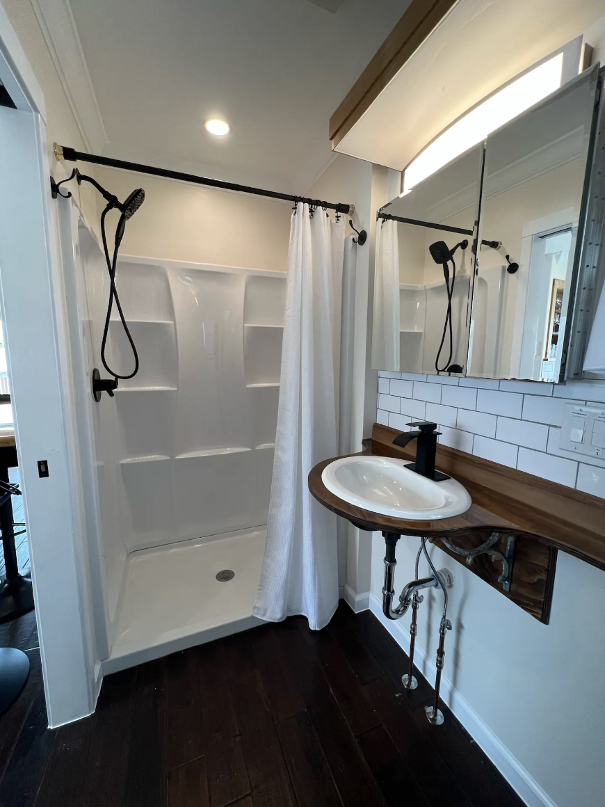 Completed bathroom inside a detached accessory dwelling unit in Denver, Colorado, built by Prenvalley Builders, featuring a walk-in shower, compact vanity, and durable finishes.