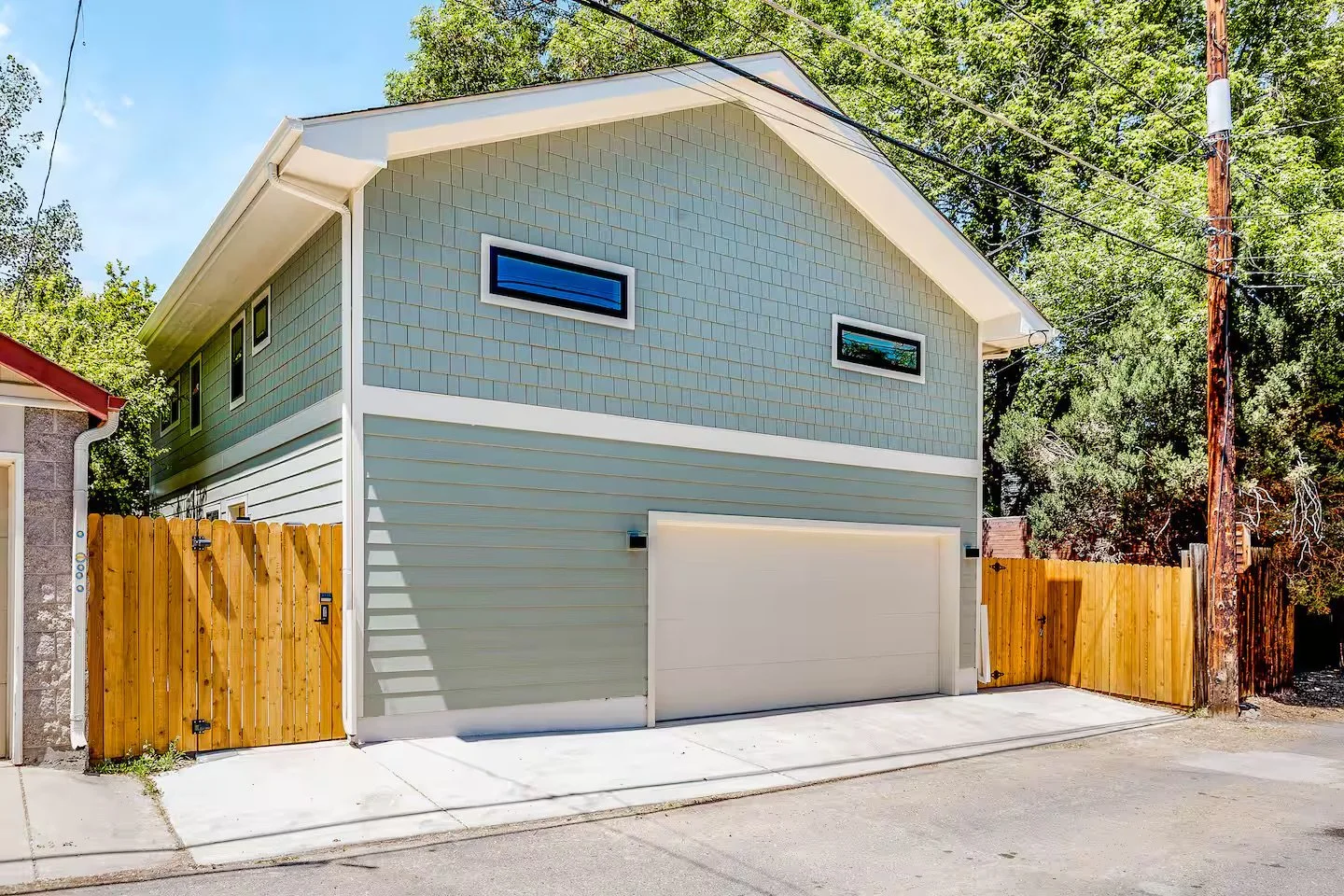 Two-story design-build ADU in Denver featuring an integrated garage, fiber cement siding, and modern window placement, built by Prenvalley Builders.