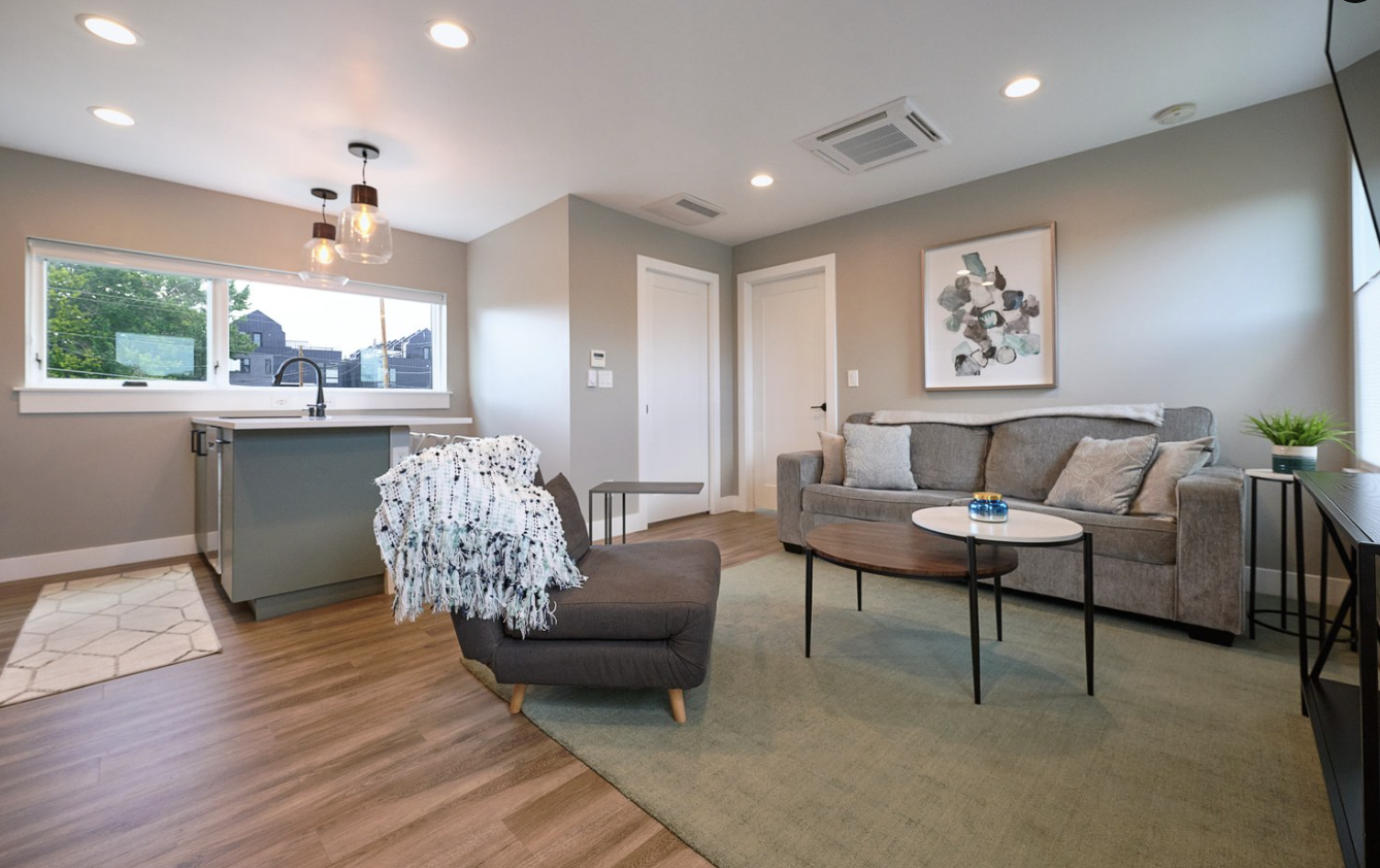 Open-concept living room and kitchen inside a Denver accessory dwelling unit featuring modern finishes, efficient layout, and natural light built by Prenvalley Builders.