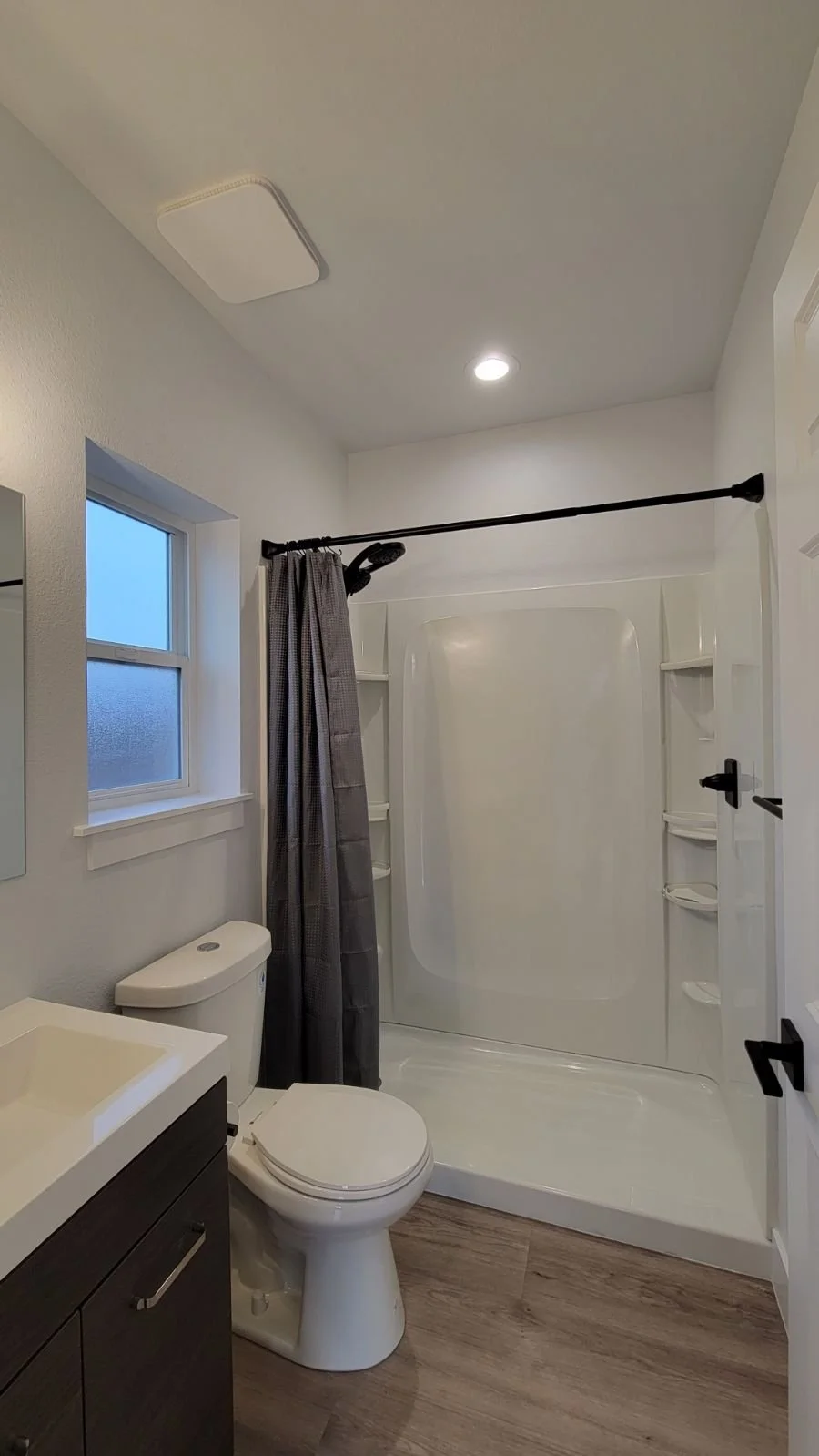 Finished bathroom inside a detached accessory dwelling unit in Denver, featuring a full tub and shower, modern fixtures, and efficient layout by Prenvalley Builders.
