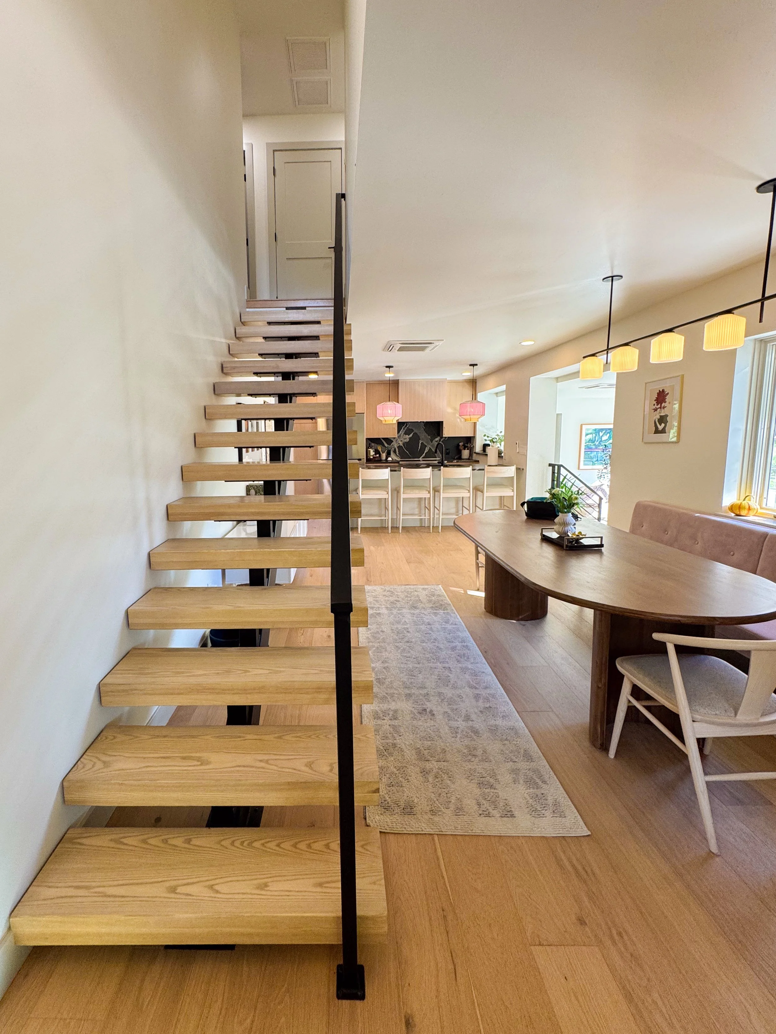 Custom open staircase within a Denver pop-top renovation connecting the new second story to the remodeled main living level