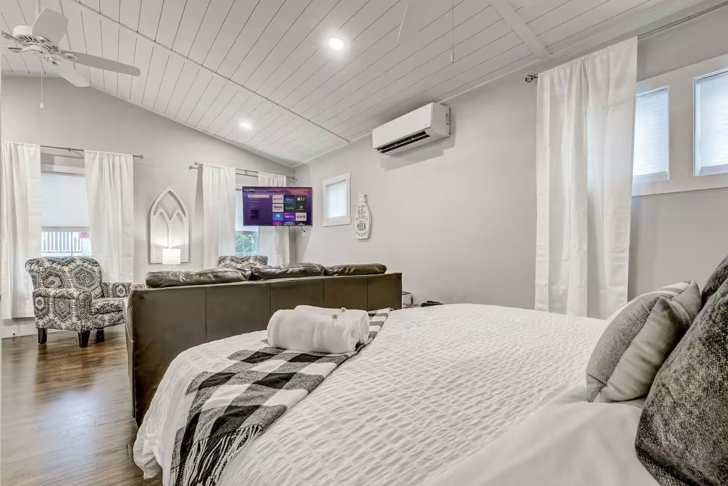 View from the bedroom toward the living area inside a detached accessory dwelling unit in Colorado Springs, Colorado, highlighting an open layout, vaulted ceiling, and efficient small-space design.