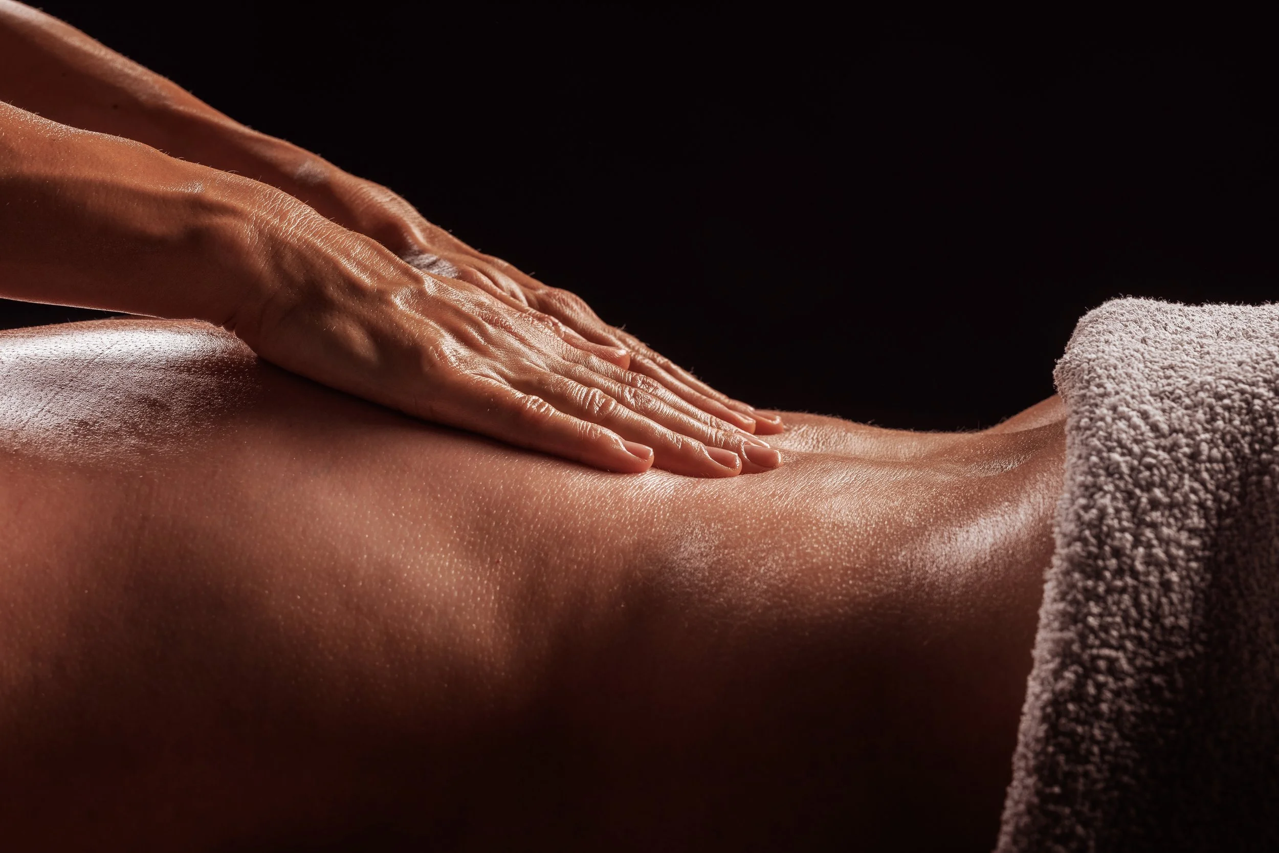 Gentle massage targeting the lower back area to relieve tension and discomfort