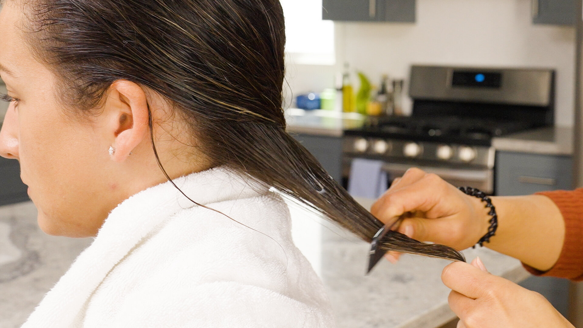  Brush the OLAPLEX hair perfector through the hair. 