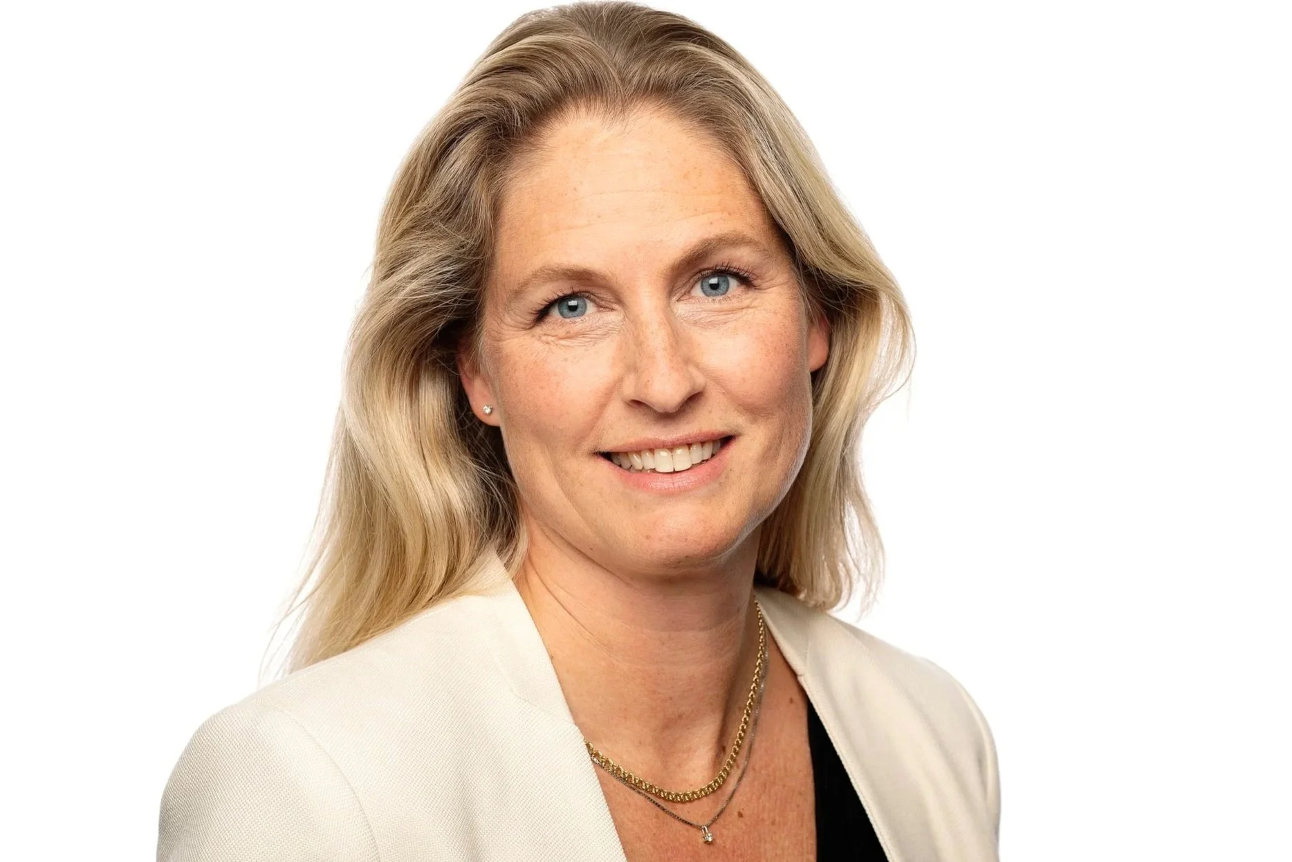 dame som smiler i en hvit blazer