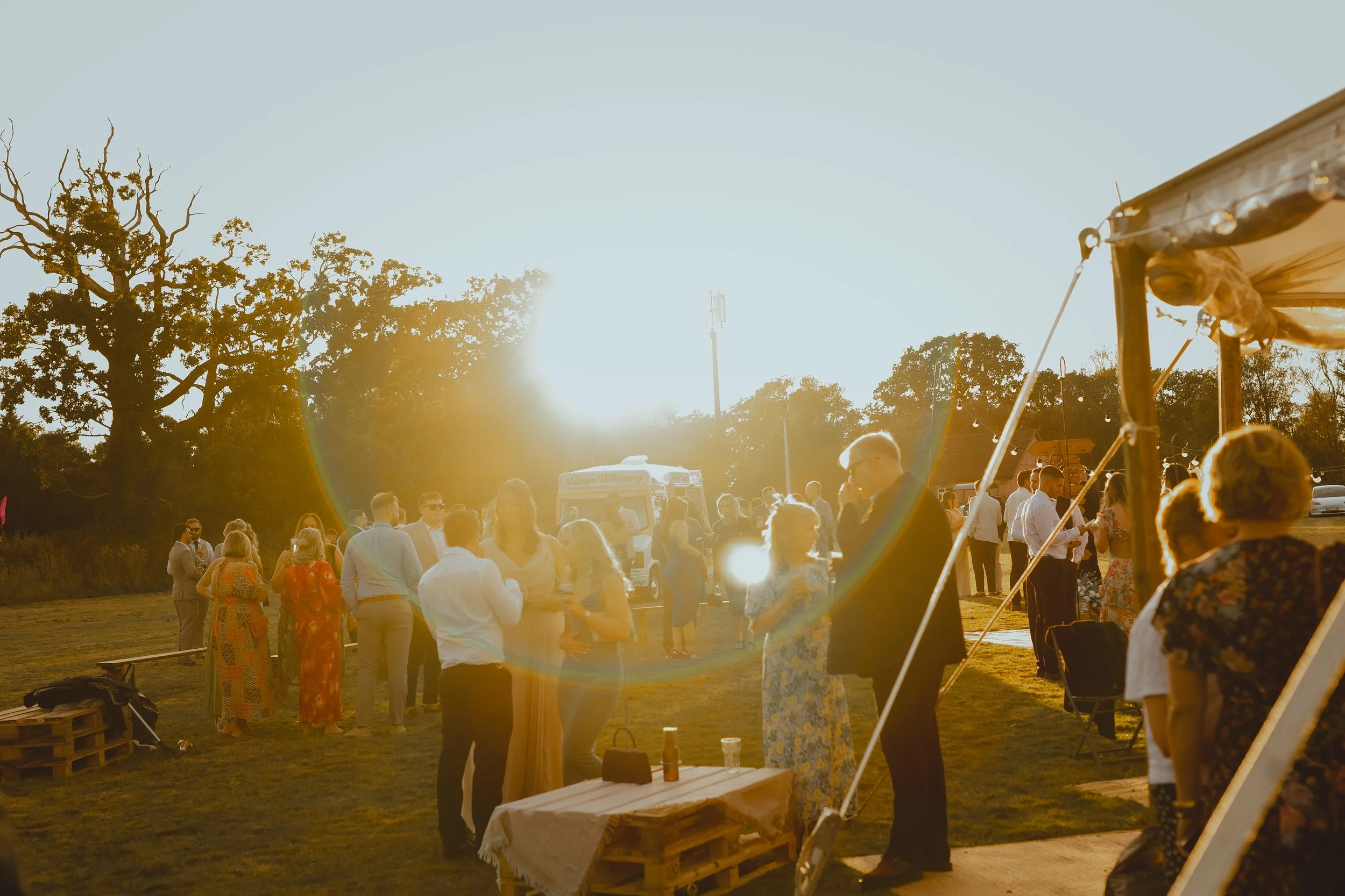 wide shot taken at an outdoor reception festival bohemian wedding with lightflare abstract painterly marquee lowestoft suffolk coast 