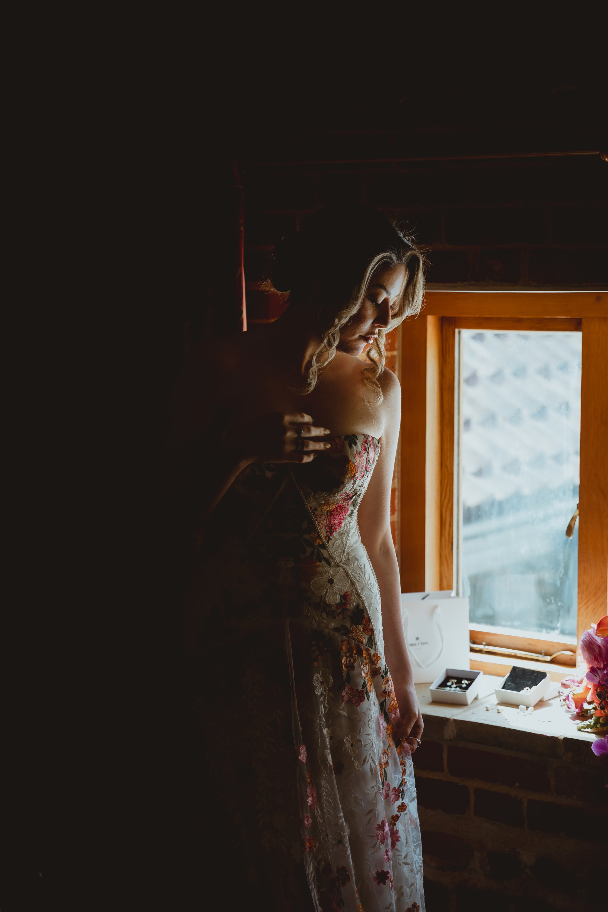 Soft moody dark editorial cinematic portrait of bride in bohemian dress getting ready for her wedding day at Chaucer Barn Gresham Holt Norfolk 