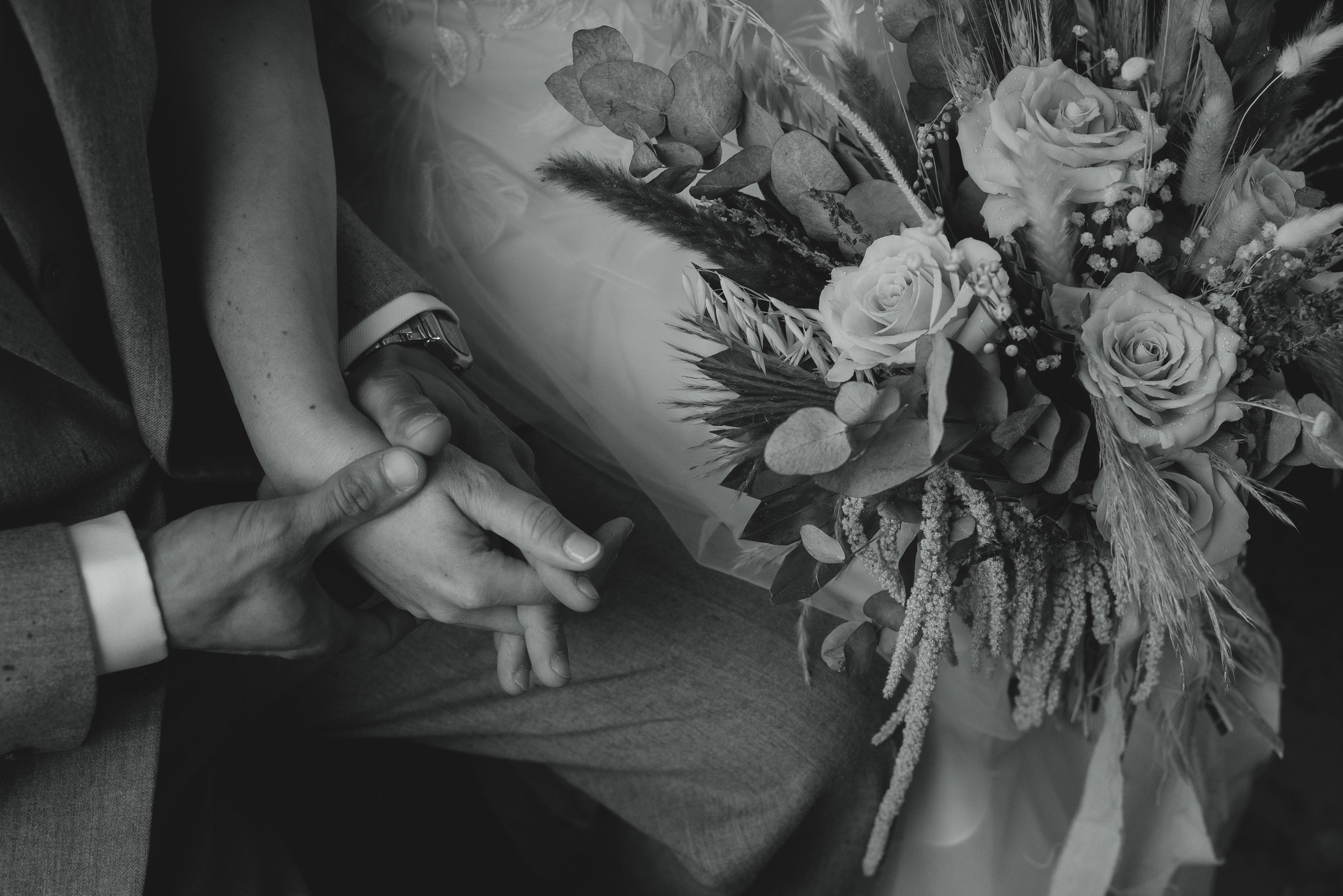 moody cinematic black and white documentary photograph or bride and groom holding hands at Strumpshaw Steam Museum railway Norwich Norfolk 