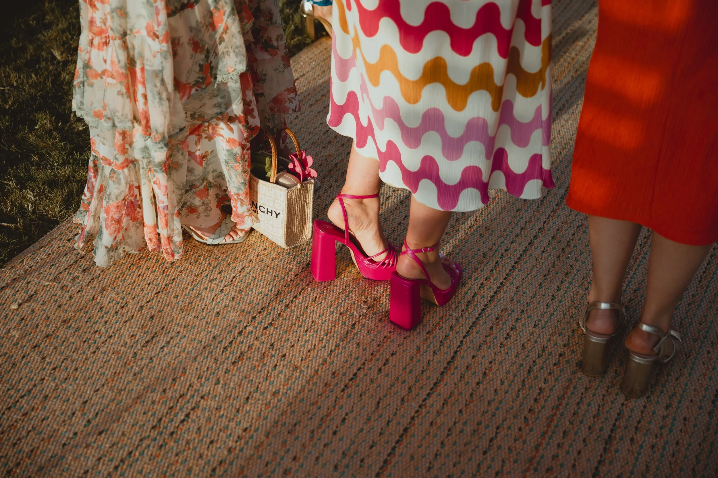 Close up of luxury bright colourful wedding outfits at outdoor marquee wedding suffolk 
