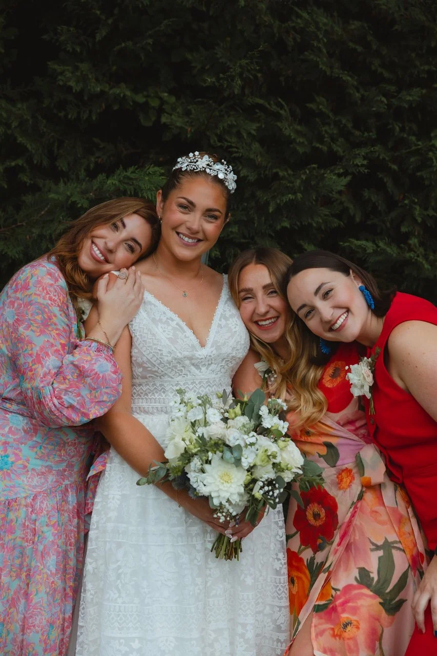 Traditional sophisticated bride in dress from Lavender and Jude with tiara white flowers and bridesmaids in vibrant rich colours at The Georgian Townhouse Norwich Norfolk 