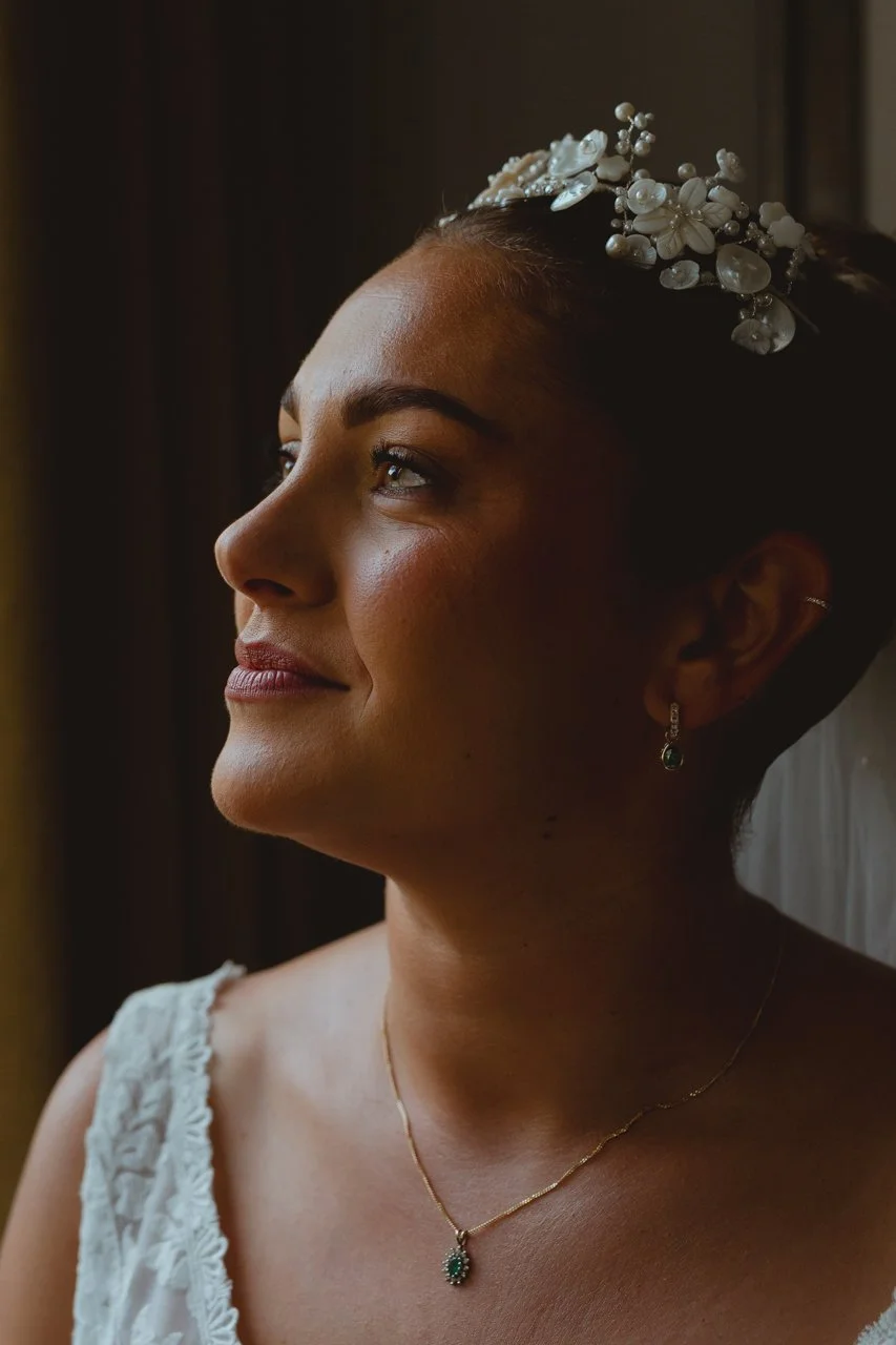 Soft elegant regal bridal portrait in window light with tiara and necklace wearing a Lavender and Jude dress at Georgian Townhouse Norwich Norfolk
