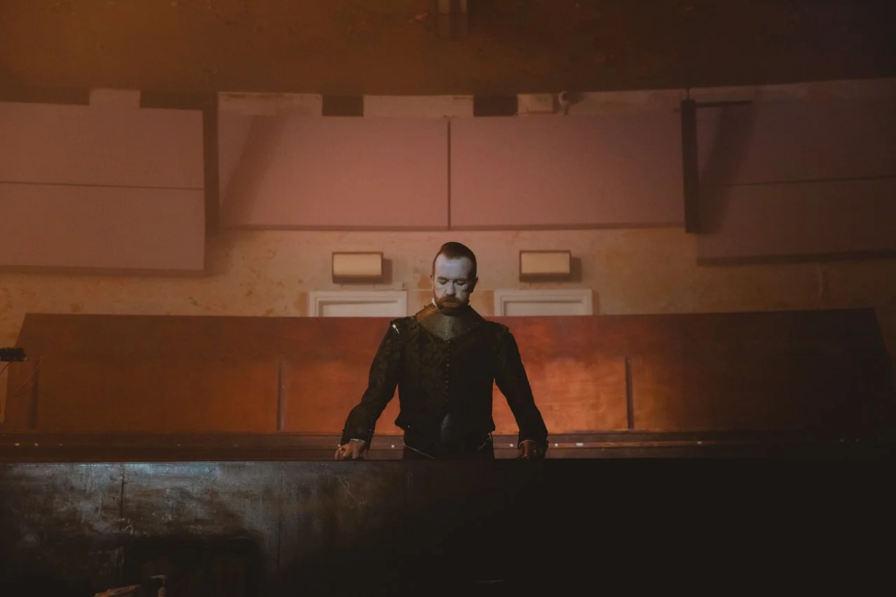 male actor with face paint on looks down over balcony at Earth Studios Dalston London 