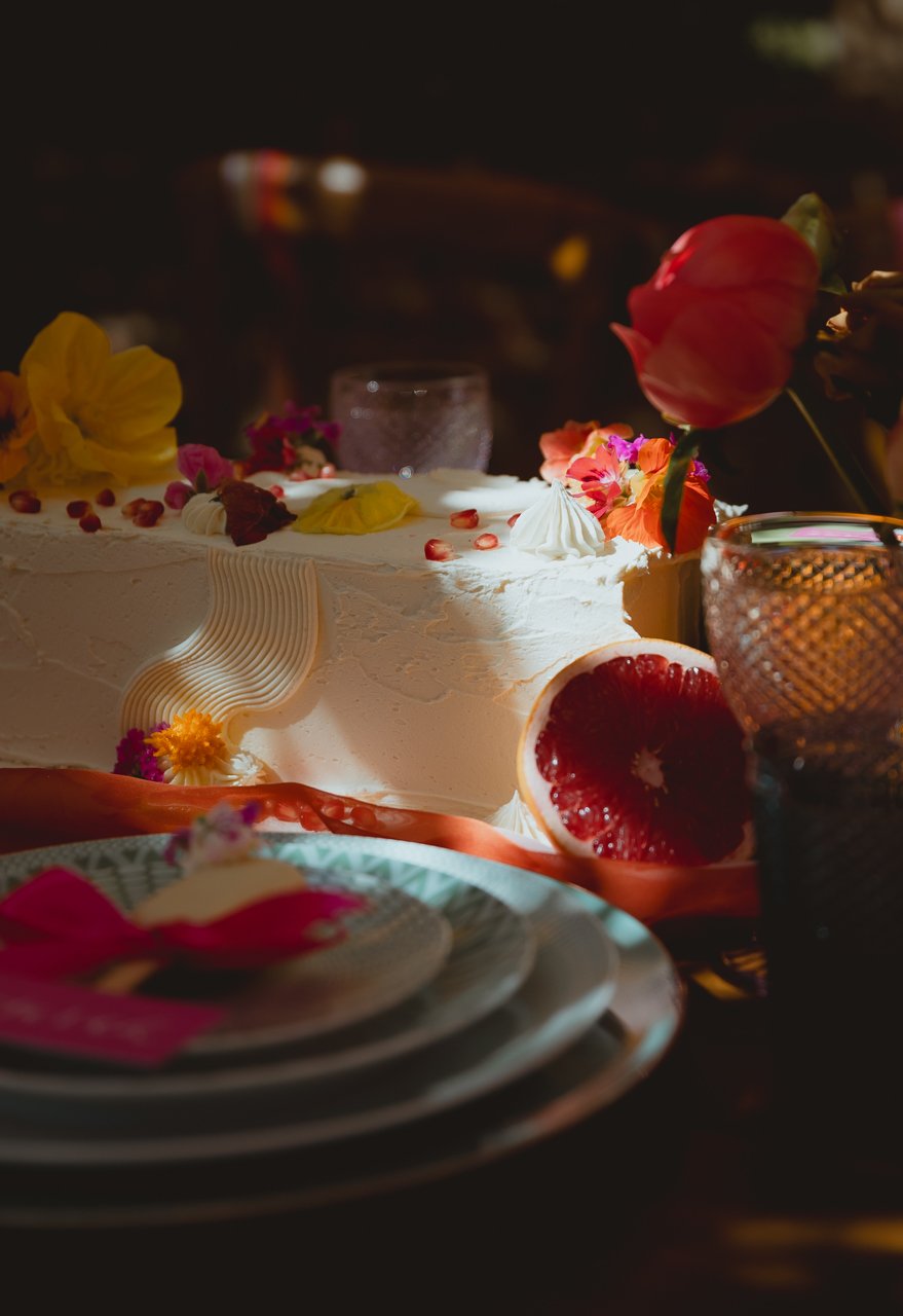stylised bohemian luxury table set up for outdoor wedding indian inspired with bright fruits plates and petals at Chaucer Barn Gresham Holt Norfolk