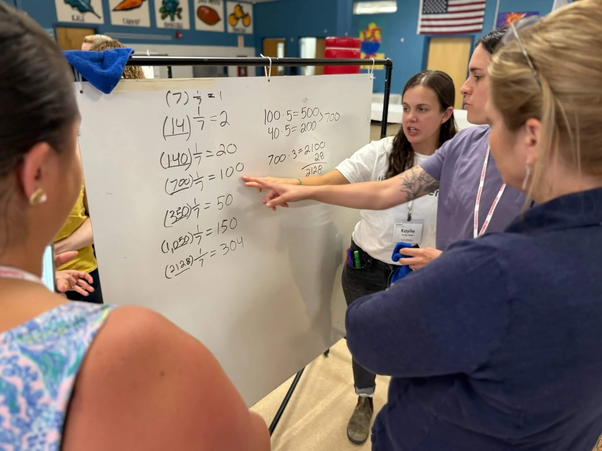 Colleagues debate and idea and get support form a coach.