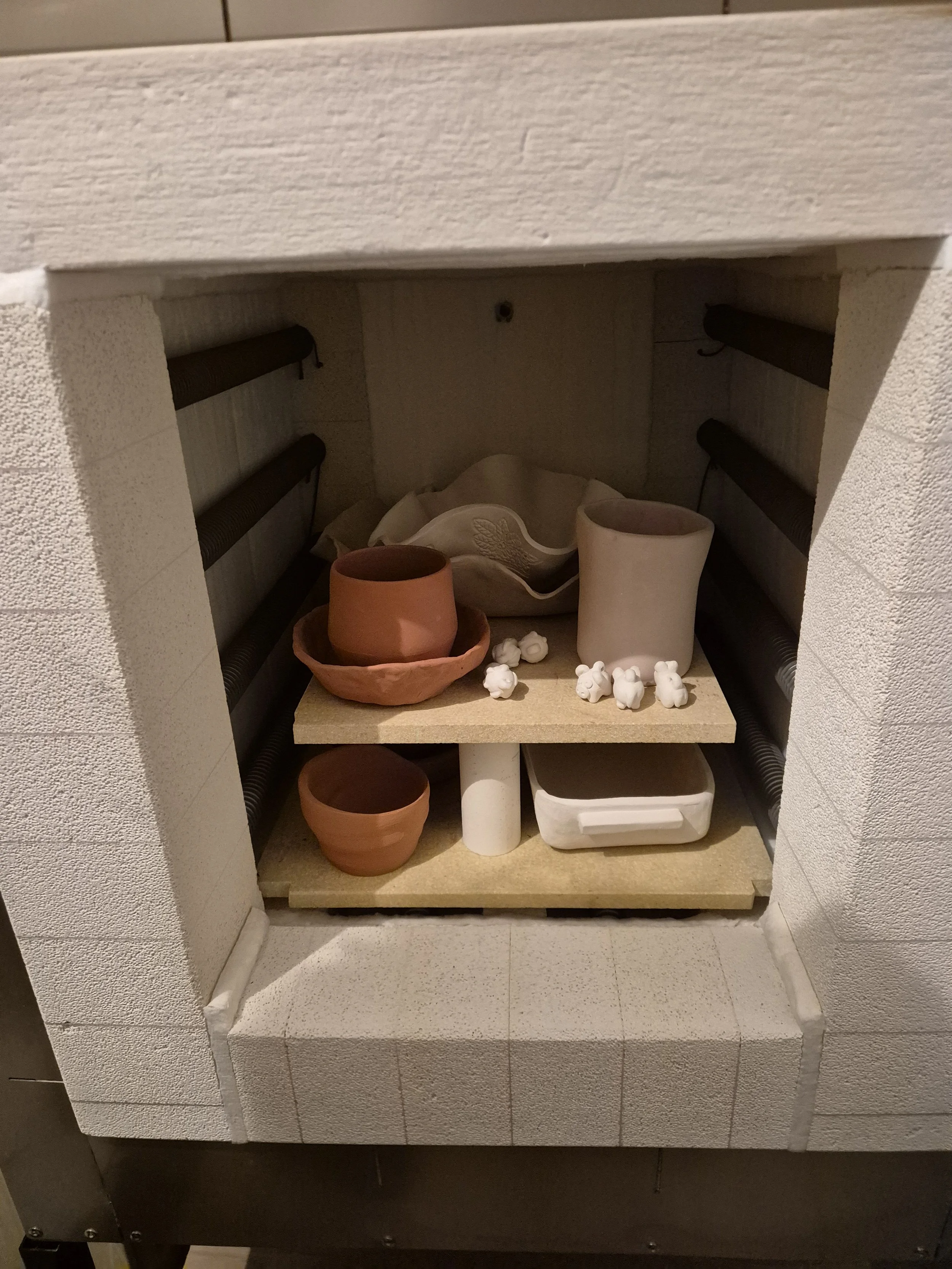 Kiln full of clay cups, pots and memorabilia.