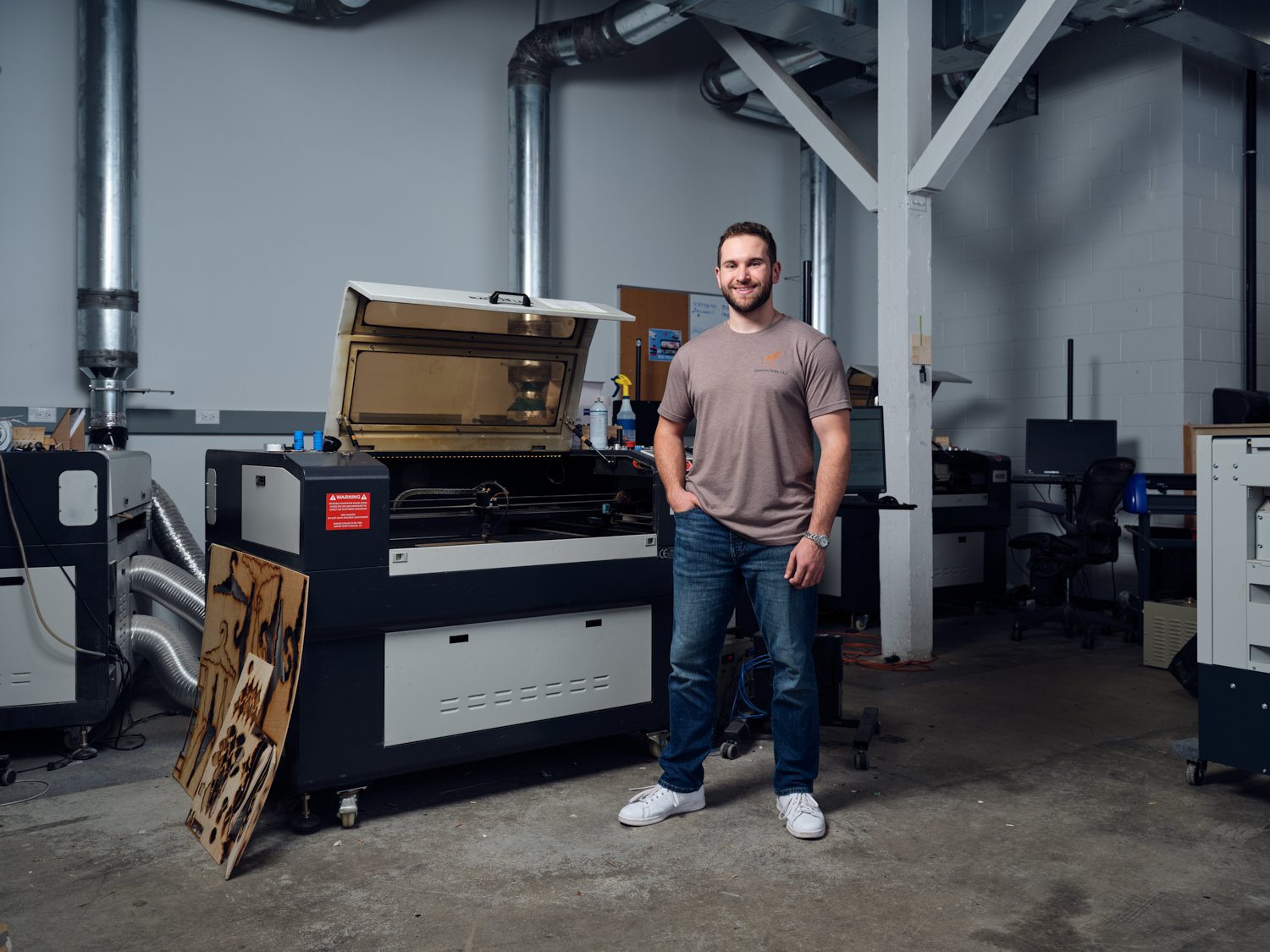 Portrait of Jack, founder of Museum Scan. He is using a laser cutter for a photography personal work series