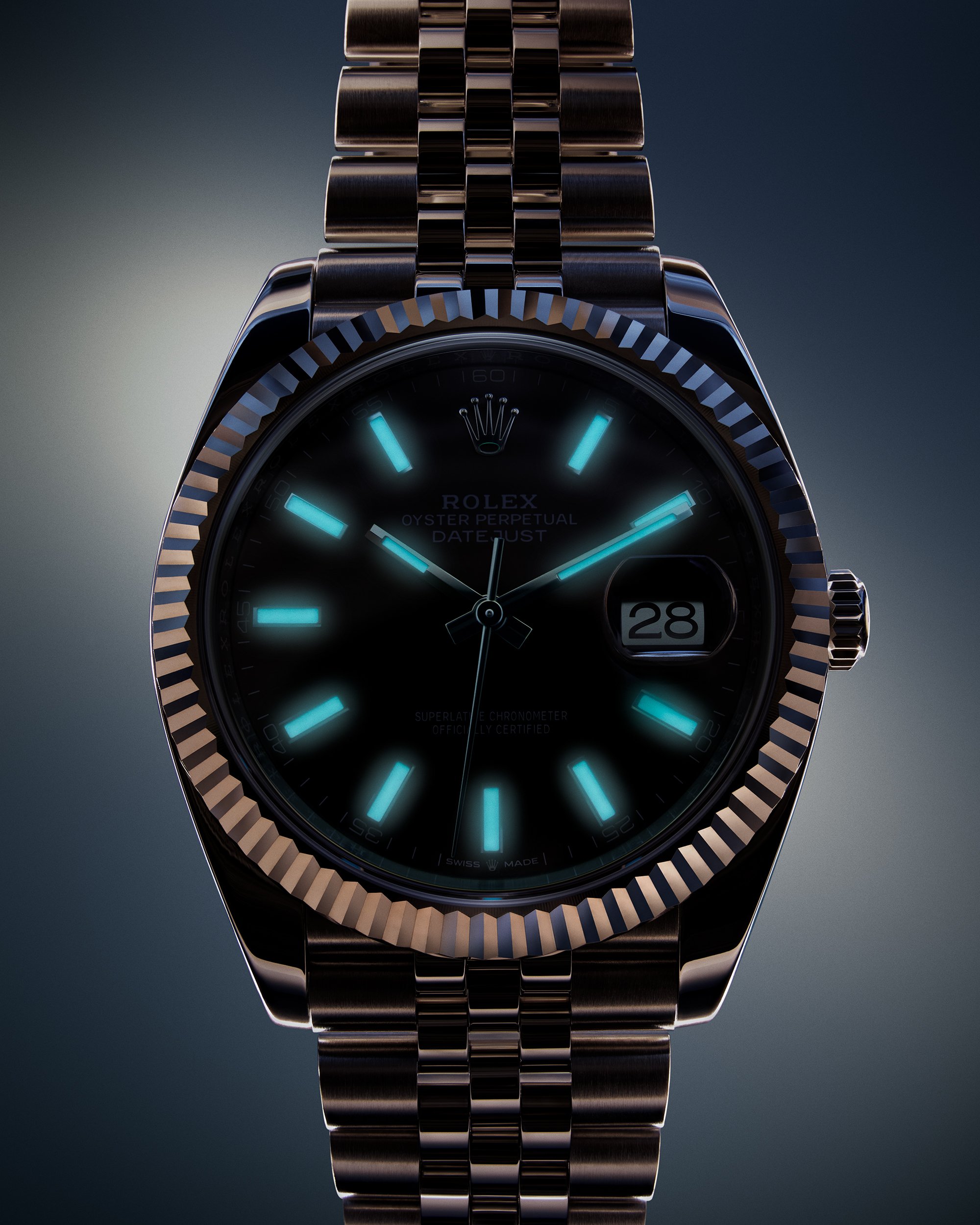 Close-up of a Rolex Oyster Perpetual Datejust watch with glowing blue luminous hour markers and hands, a date window at 3 o'clock, and a metallic bracelet.