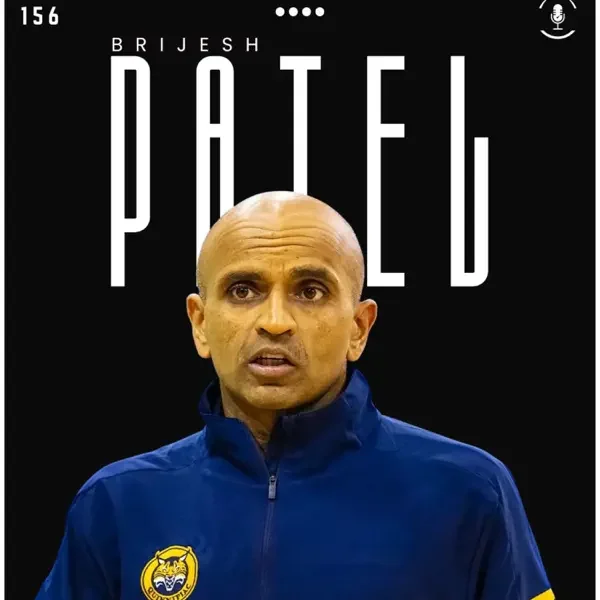 The image features a man with a closely shaved head and intense expression, wearing a blue jacket with an embroidered logo. Behind him, there is stylized text that reads 'Brijesh Patel', and the top of the image shows the number 156 and some symbols. It appears to be a promotional or poster image.