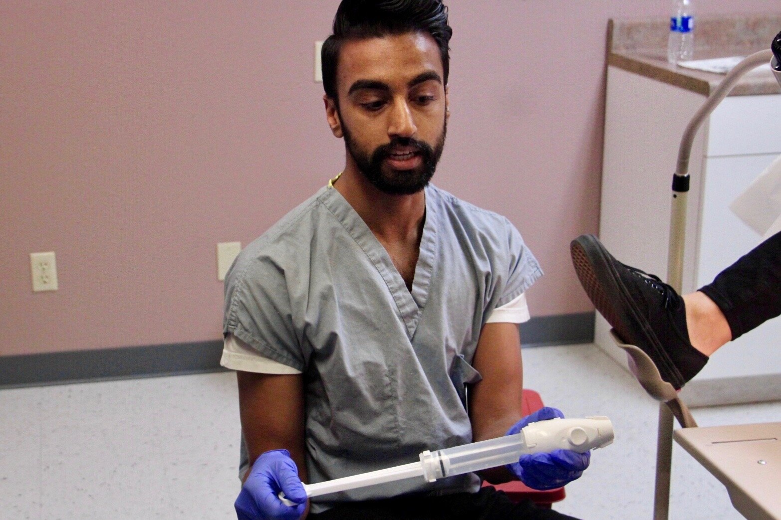 Dr. Kumar demonstrates the use of a manual vacuum aspirator (MVA)
