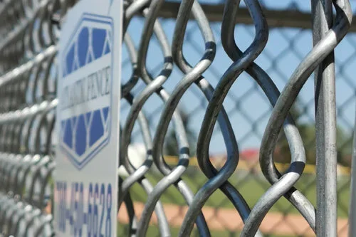 Chain link fence post repair in progress in Edmonton