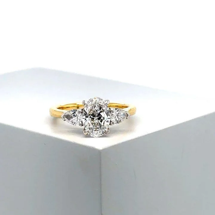 ANG&Eacute;LIQUE
&bull;
She speaks for herself. She is bold and feminine all at once. 
&bull;
This beauty features a stunning 1.20ct Oval diamond in the centre, accented by two perfectly proportioned pear cut diamonds. The pear cut diamonds tapering 