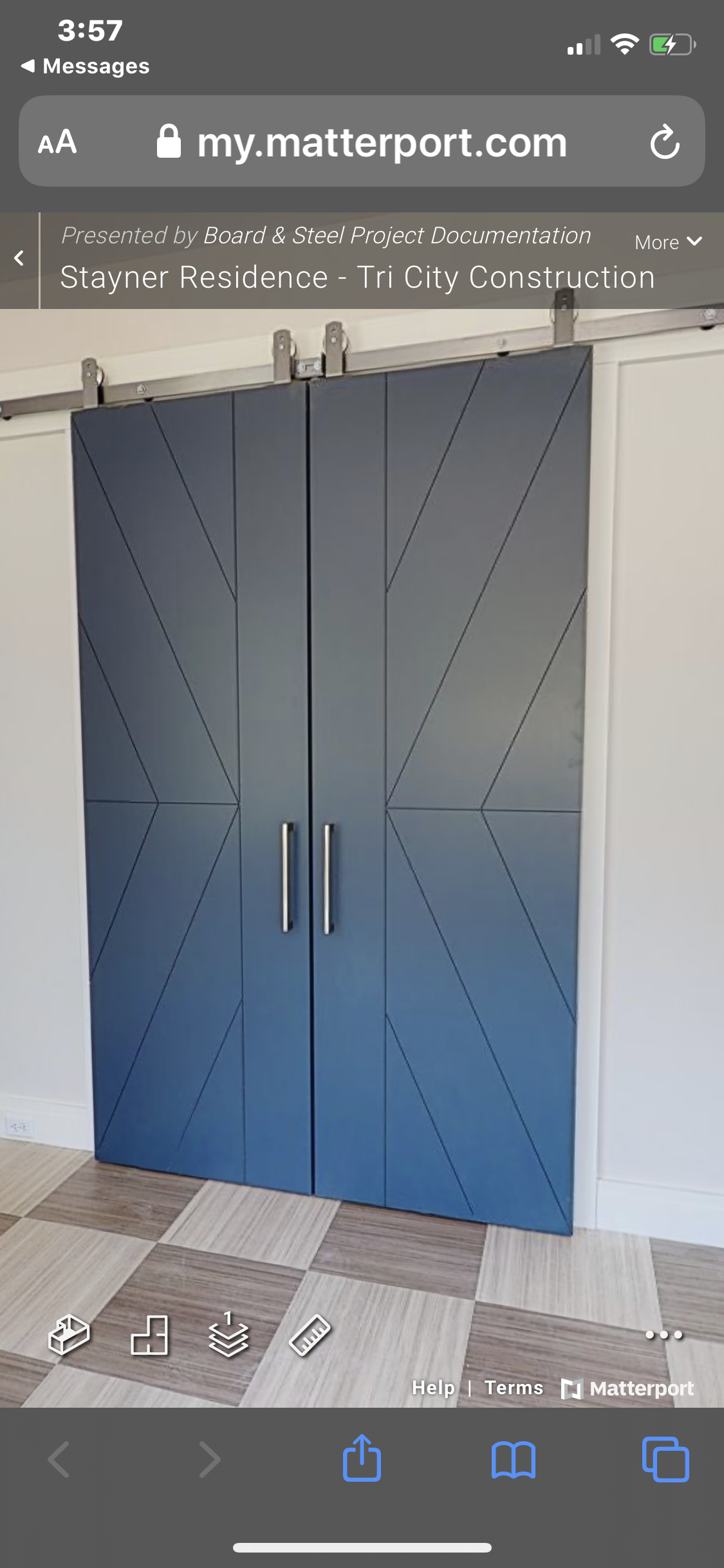 Blue cabinet with geometric line patterns and silver handles, on a tiled floor, part of a residential space.