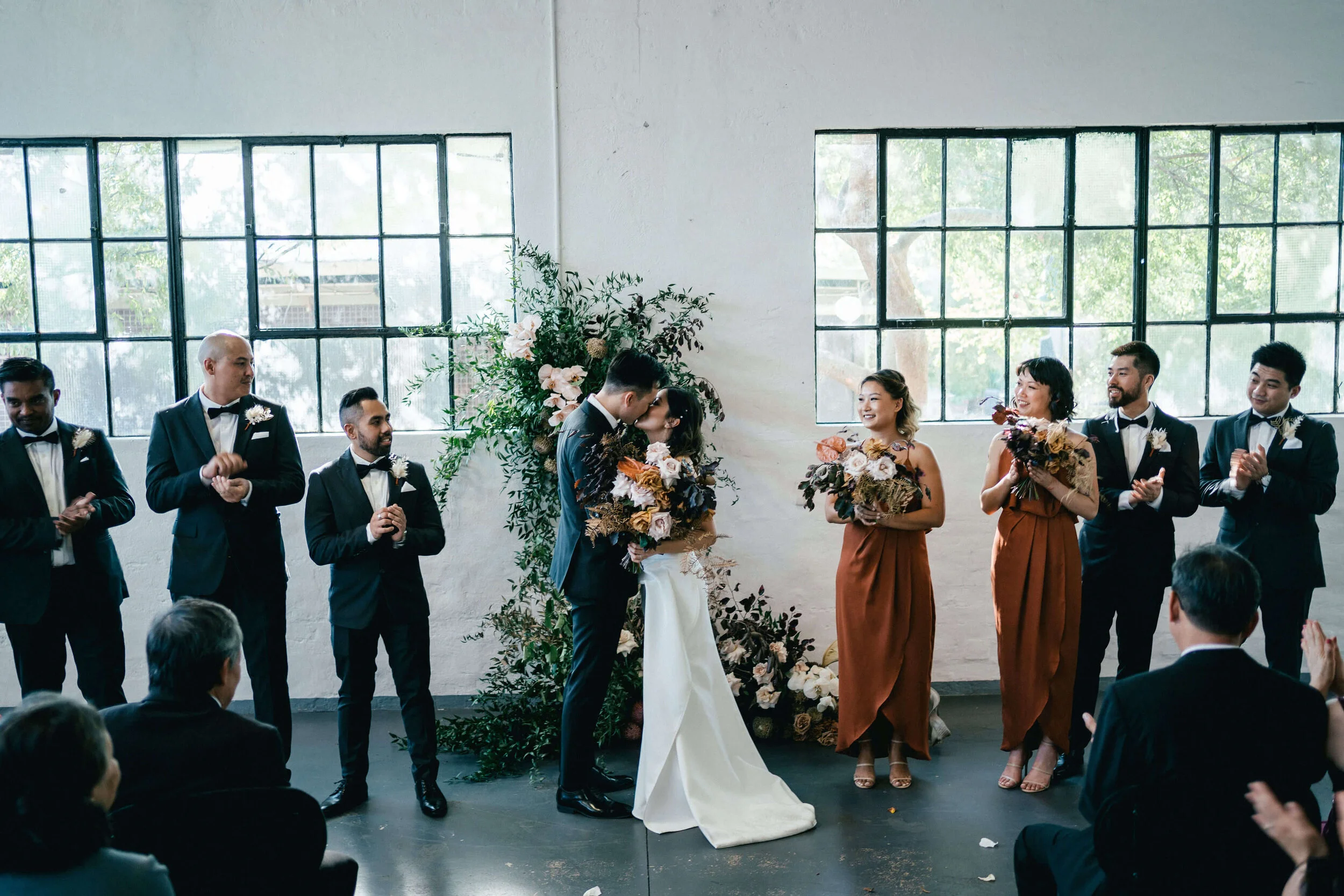 Bride and groom kissing at altar
