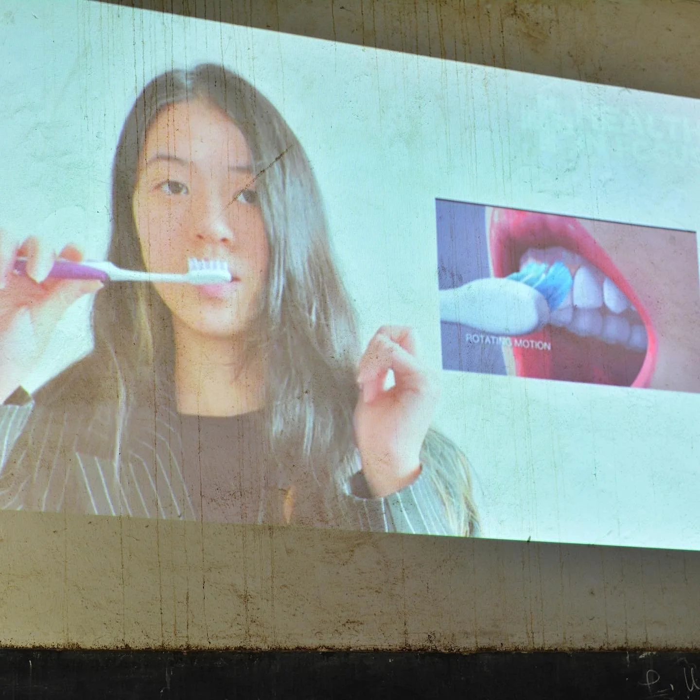 Woman brushing her teeth with a manual toothbrush beside a diagram showing circular brushing motion.