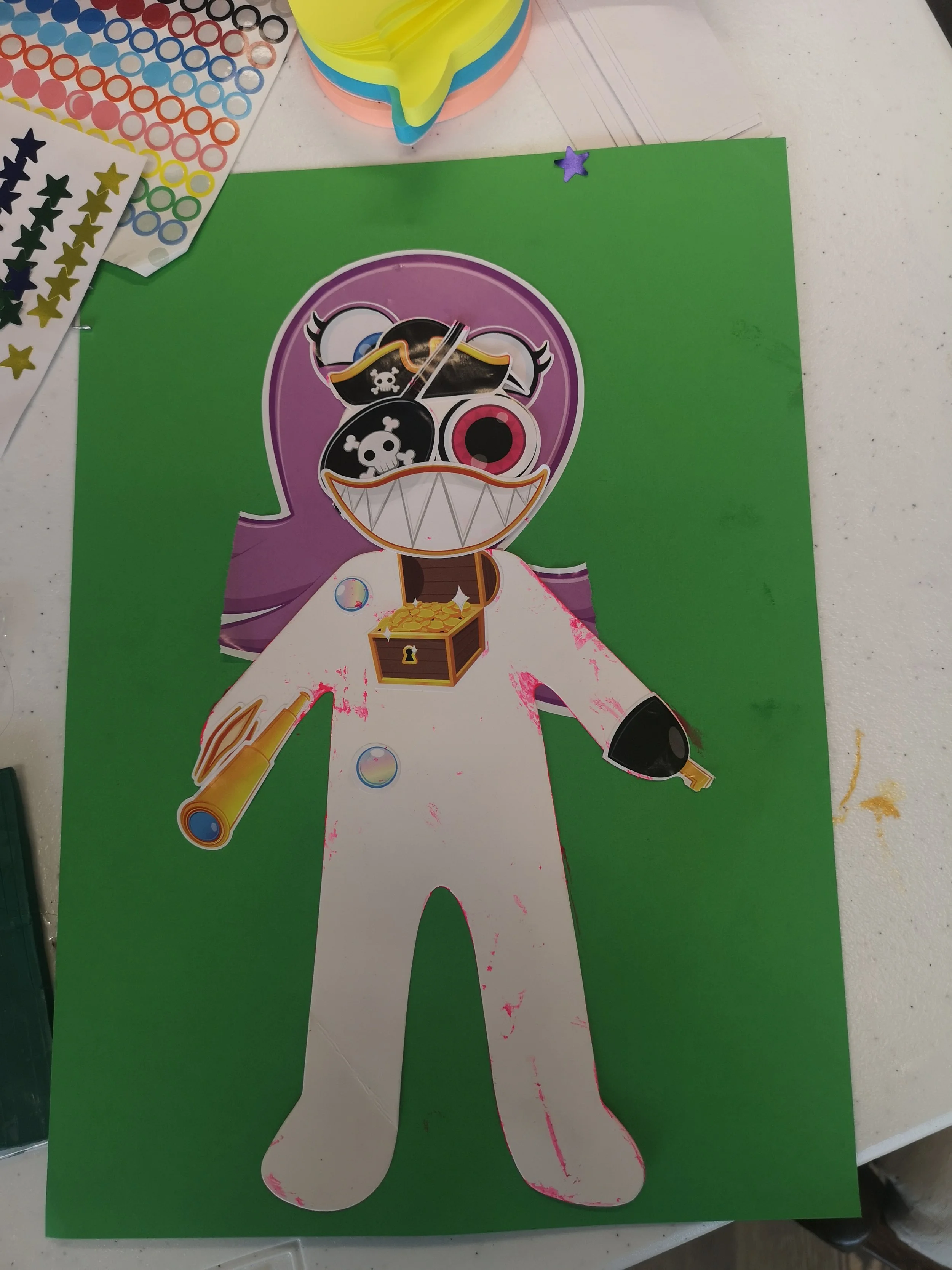 A anon on a green background with purple hair, a hock-hand and a skull and crossbones for one eye.

