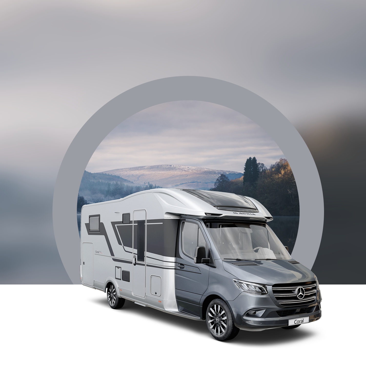 Luxury motorhome with scenic mountain background.