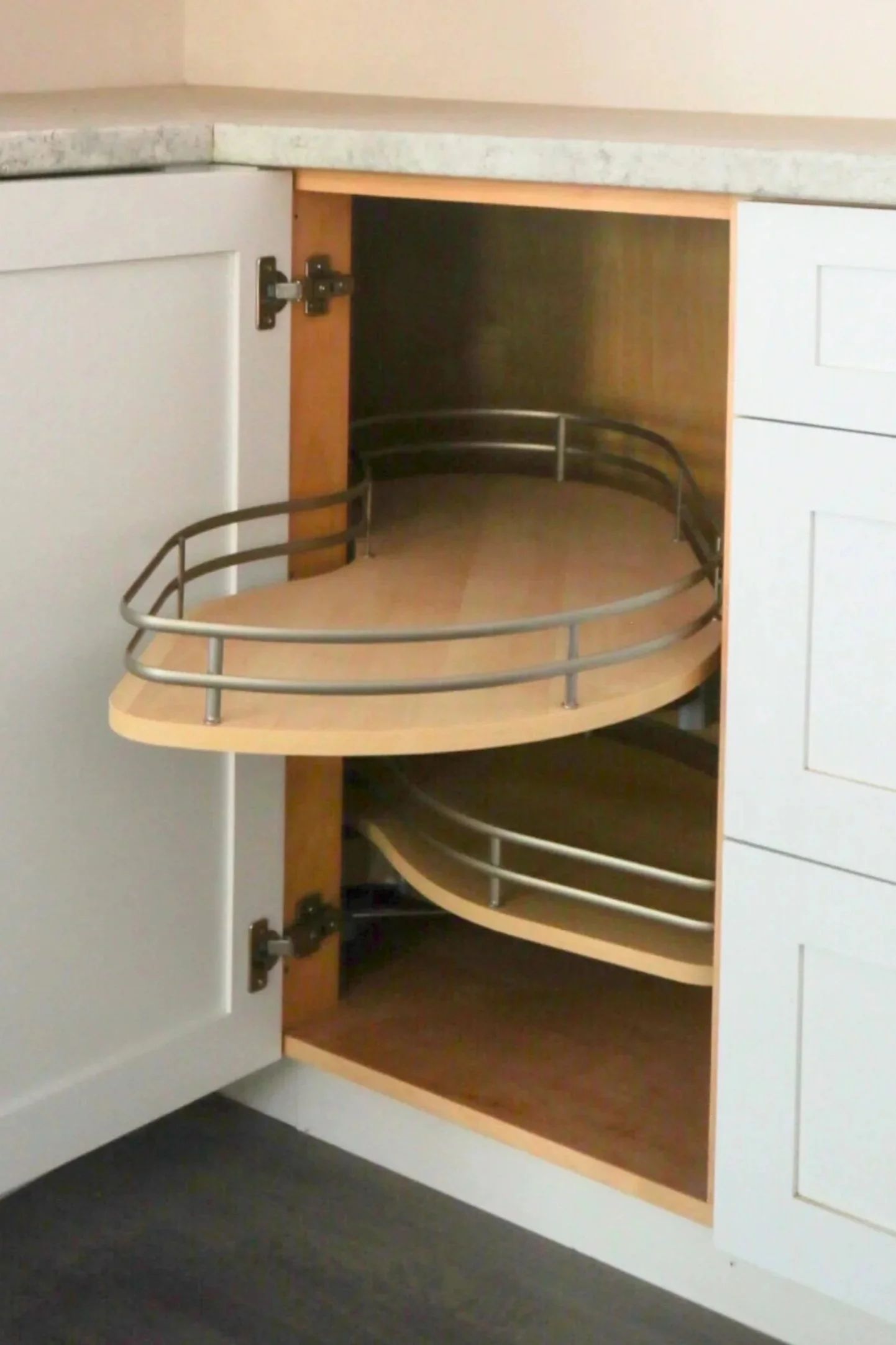 Open kitchen cabinet with a flymoon or LeMan's unit inside.