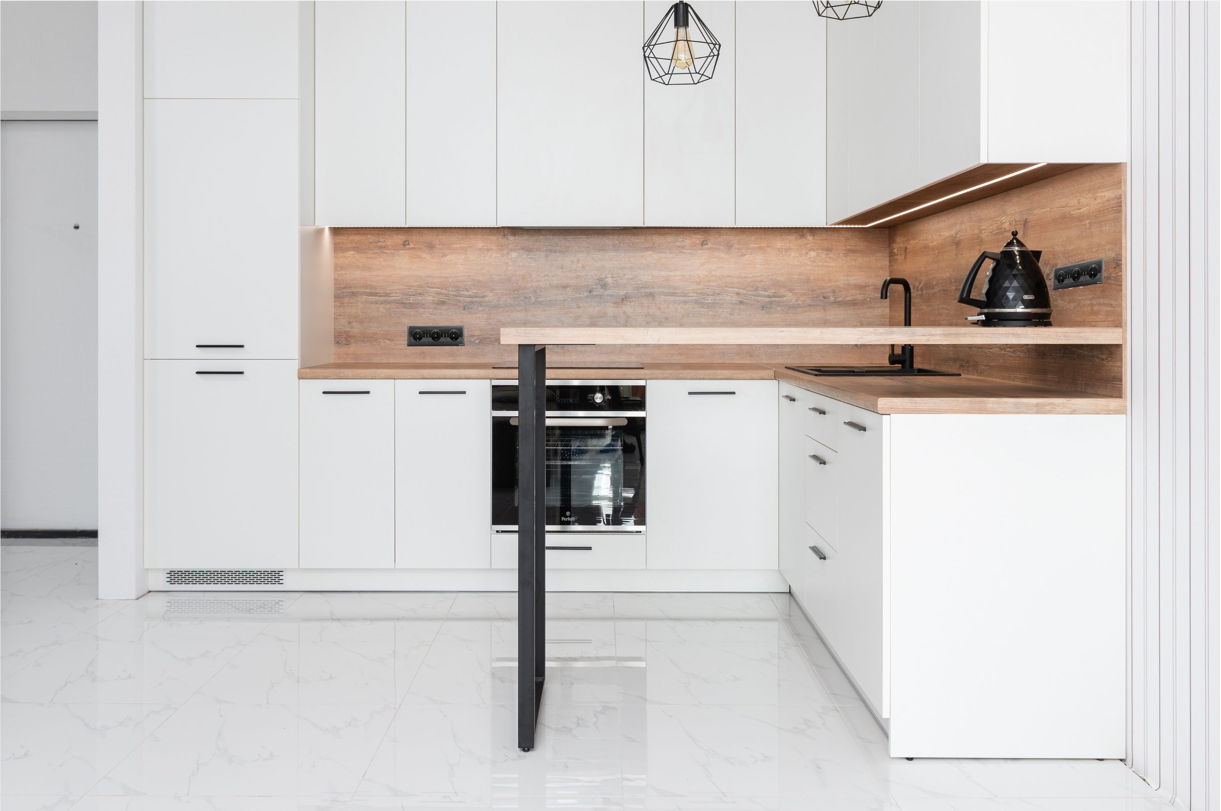 Modern kitchen with white cabinets, wooden countertops and backsplash, black faucet, kettle, and stove, with a white marble floor.