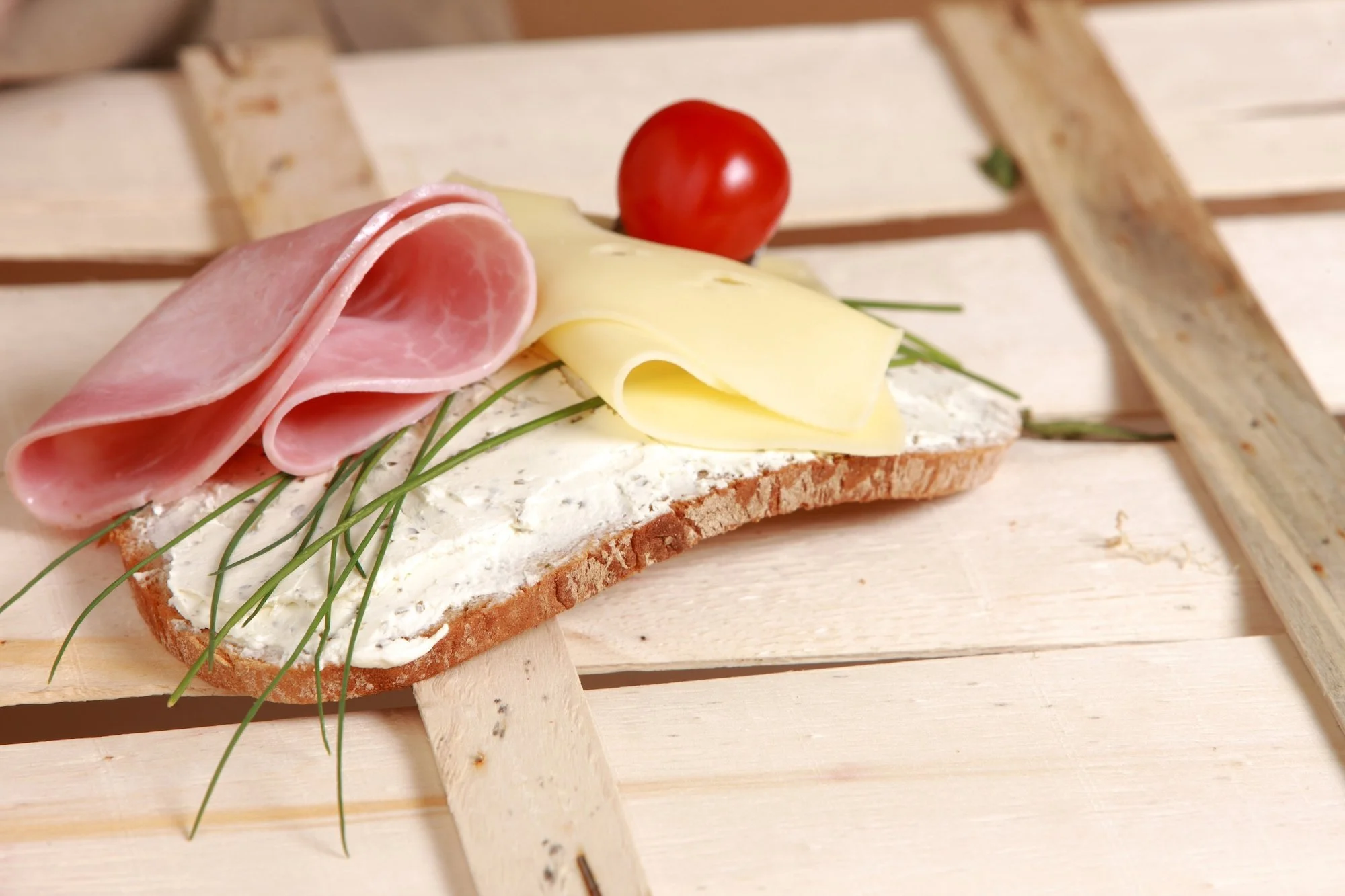 Stulle, a slice of bread with a spread, cold cuts, and vegetables