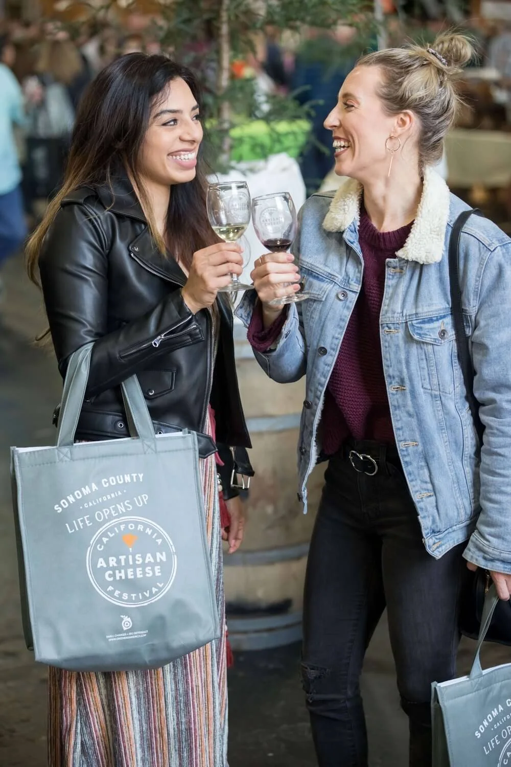 Girls cheersing with CACF totes